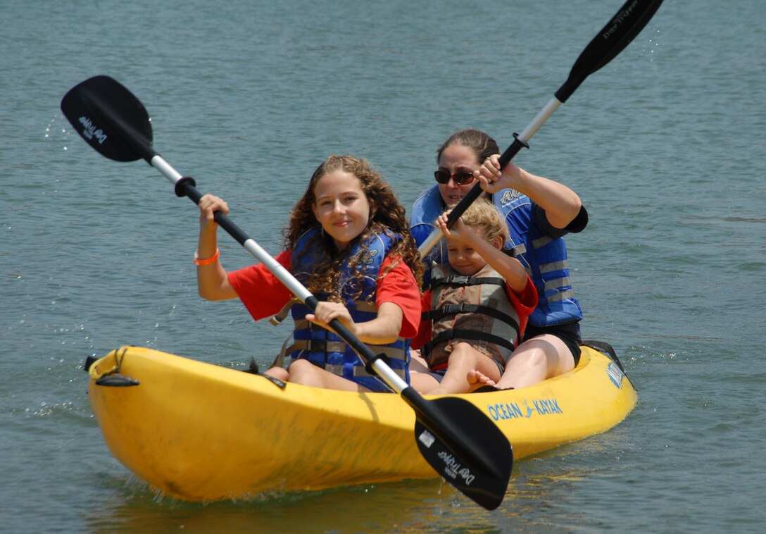 Two sisters and their youth counselor enjoy a day of kayaking and fun at Mothers Beach in Long Beach, California. The Air Force recently partnered with the National Park Trust to bring the Buddy Bison Great Outdoors Challenge to military families at several installations. The program encourages children and families to spend less time in front of a screen and more time outdoors. (Courtesy photo by Joseph Juarez)