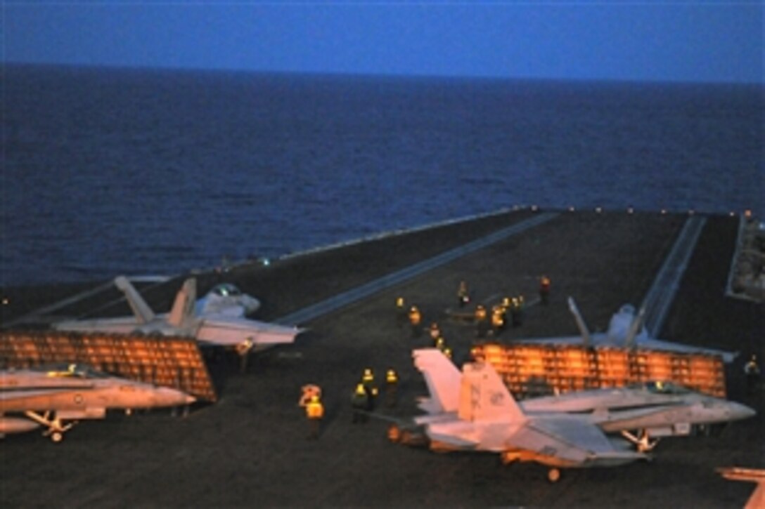 Aircraft are readied for launch off the bow catapults of the USS Ronald Reagan during night flight operations, Pacific Ocean, July 11, 2008. The USS Ronald Reagan Carrier Strike Group is on a routine deployment to the U.S. 7th Fleet area of responsibility in the western Pacific and Indian Oceans. 