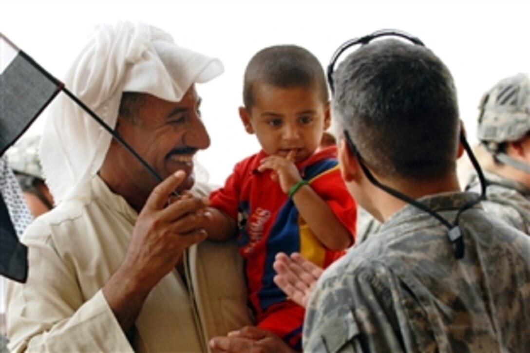 U.S. Army Maj. Mario Caycedo, a surgeon, talks with an Iraqi boy and his father during a cooperative medical engagement in Juhaysh, Iraq, July 9, 2008. Caycedo is assigned to the 703rd Brigade Support Battalion. 


4th Brigade Combat Team, 3rd Infantry Division 
