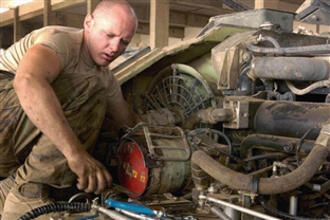 U.S. Army Pvt. 1st Class Anthony Venson works on reinstalling the engine of a Bradley fighting vehicle on Combat Outpost Summers, Iraq, July 9, 2008. Venson is a Bradley mechanic assigned to Company B, 2nd Battalion, 6th Infantry Regiment.