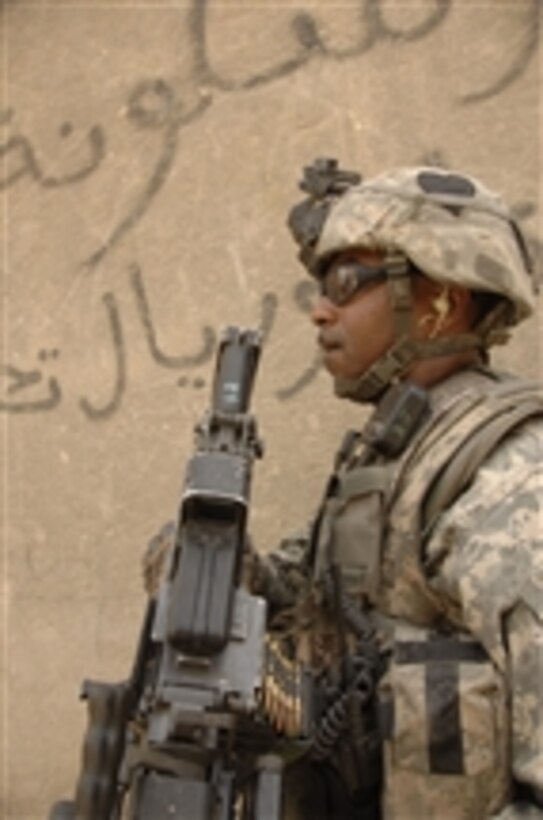 U.S. Army Sgt. Warren Bryson provides security during a combined patrol with Iraqi police officers in the Gazaliyah district of Baghdad, Iraq, on July 8, 2008.  This patrol is also a mission to hand out micro-grant applications to area business owners.  Bryson is assigned to the 4th Platoon, Bravo Troop, 1st Squadron, 75th Cavalry Regiment, 2nd Brigade Combat Team, 101st Airborne Division.  