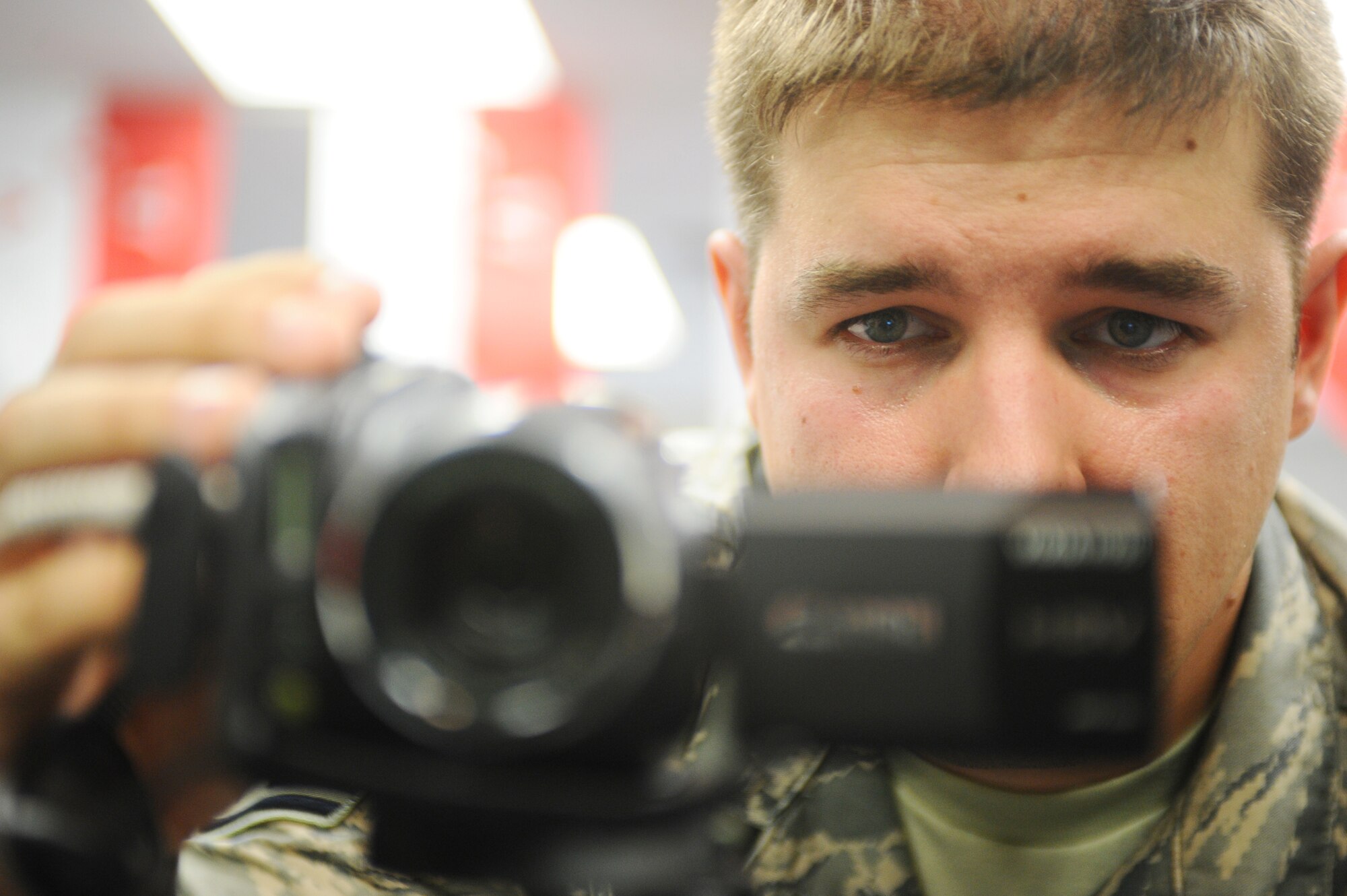 Staff Sgt. James Warren, 354th Fighter Wing chaplain's assistant, adjusts settings on his video camera prior to recording deploying members July 16, 2008, at Fort Wainwright. Sergeant Warren and his wife, Shelly, decided to put their video editing skills and altruism to use by videotaping deploying Airmen and Soldiers in the local area while they read bedtime stories to their children free of charge.  (U.S. Air Force photo by Airman 1st Class Jonathan Snyder)