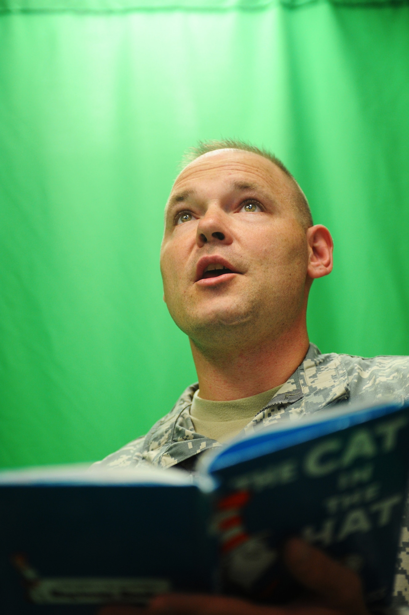 Army Sgt. 1st Class Maynard Hinkle, Task Force Saber, 6th Squadron, 17th Calvary, reads The Cat in the Hat July 16, 2008 at Fort Wainwright. Sergeant Hinkle has been on many deployments, including Afghanistan and Bosnia and has never, until now, had the capability to communicate via video recording to his children. (U.S. Air Force photo by Airman 1st Class Jonathan Snyder)
