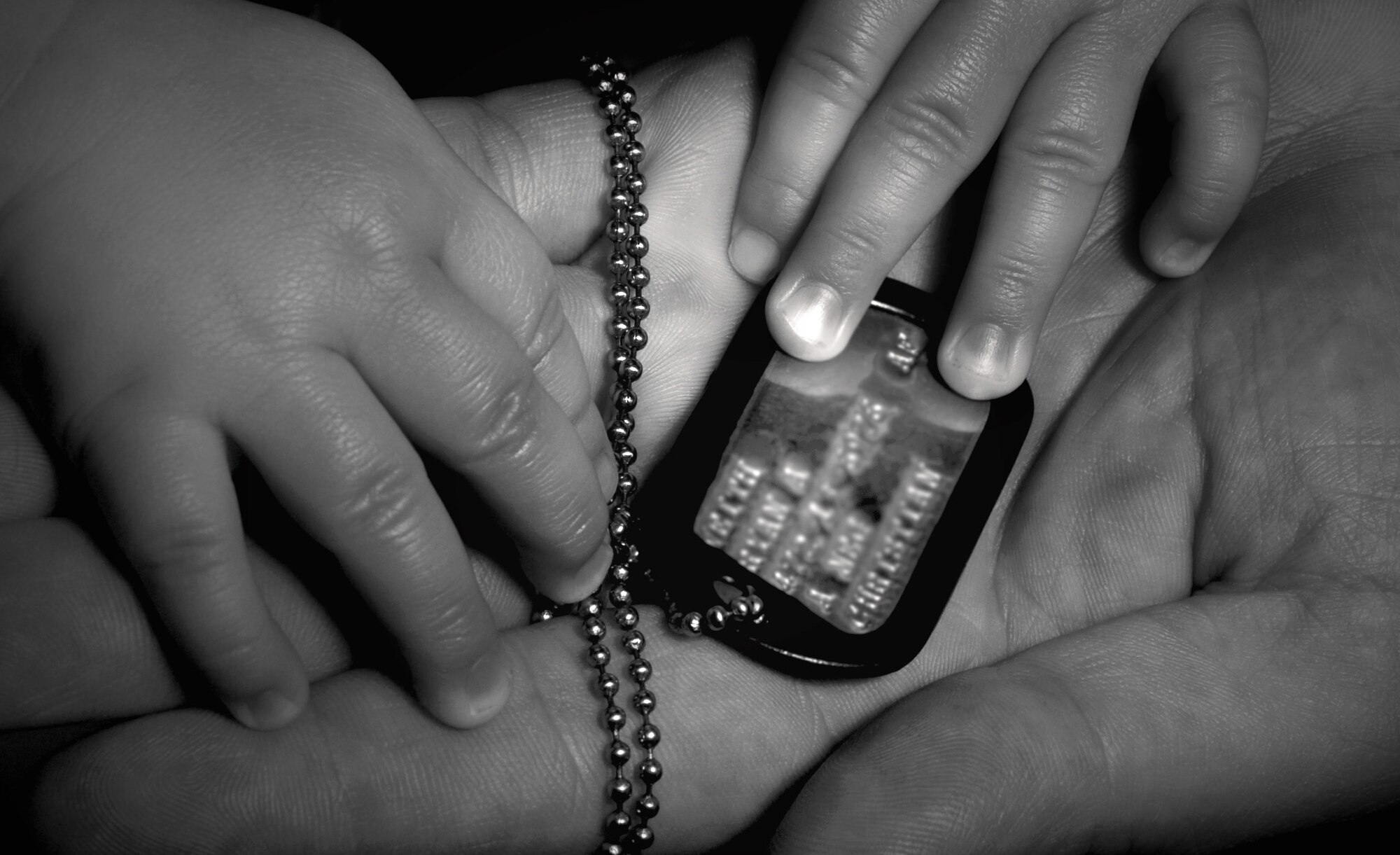 Members of the Air Force who deploy find small ways for their children to remain close to them during their deployment. Staff Sgt. Ryan Veith, who was deployed to Iraq the moment his son was born, allows his son R.J.  to play with one of his dog tags. Sergeant Veith has deployed eight times and is set to leave for his ninth deployment in July. He plans on leaving a duplicate set of his dog tags for his son during his next deployment.  Sergeant Veith is a military working dog handler for the 354th Security Forces Squadron Eielson, Air Force Base, Alaska.

(U.S Air Force photo by TSgt Eric T. Sheler)