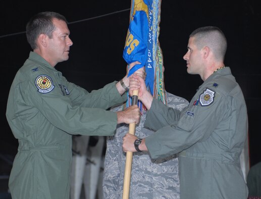 WHITEMAN AIR FORCE BASE, Mo.,- Col. Scott Kindsvater, U.S. Air Force Weapons School commandant, presents Lt. Col. Rodney P. Cousins with the 325th Weapons Squadron guidon during a change of command ceremony here July 11. Colonel Cousins assumed command of the 325th WPS from Lt. Col. Andy Gebara. (U.S. Air Force Photo/Staff Sgt. Charles Larkin Jr.)