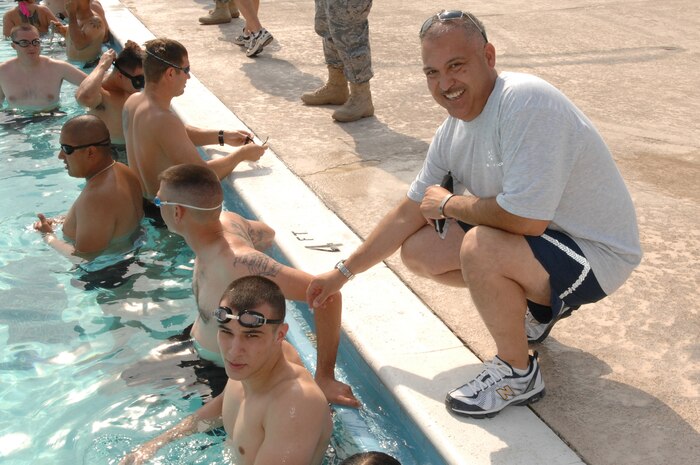 NELLIS AIR FORCE BASE, Nev. -- Master Sgt. Rudy Martinez, operations superintendent, 99th Security Forces Squadron, takes a moment to help motivate some of his troops during a recent quarterly Security Forces Group competition at the base pool here, July 11, 2008.  (U.S. Air Force photo  / Senior Airman Kasabyan D. Musal)
