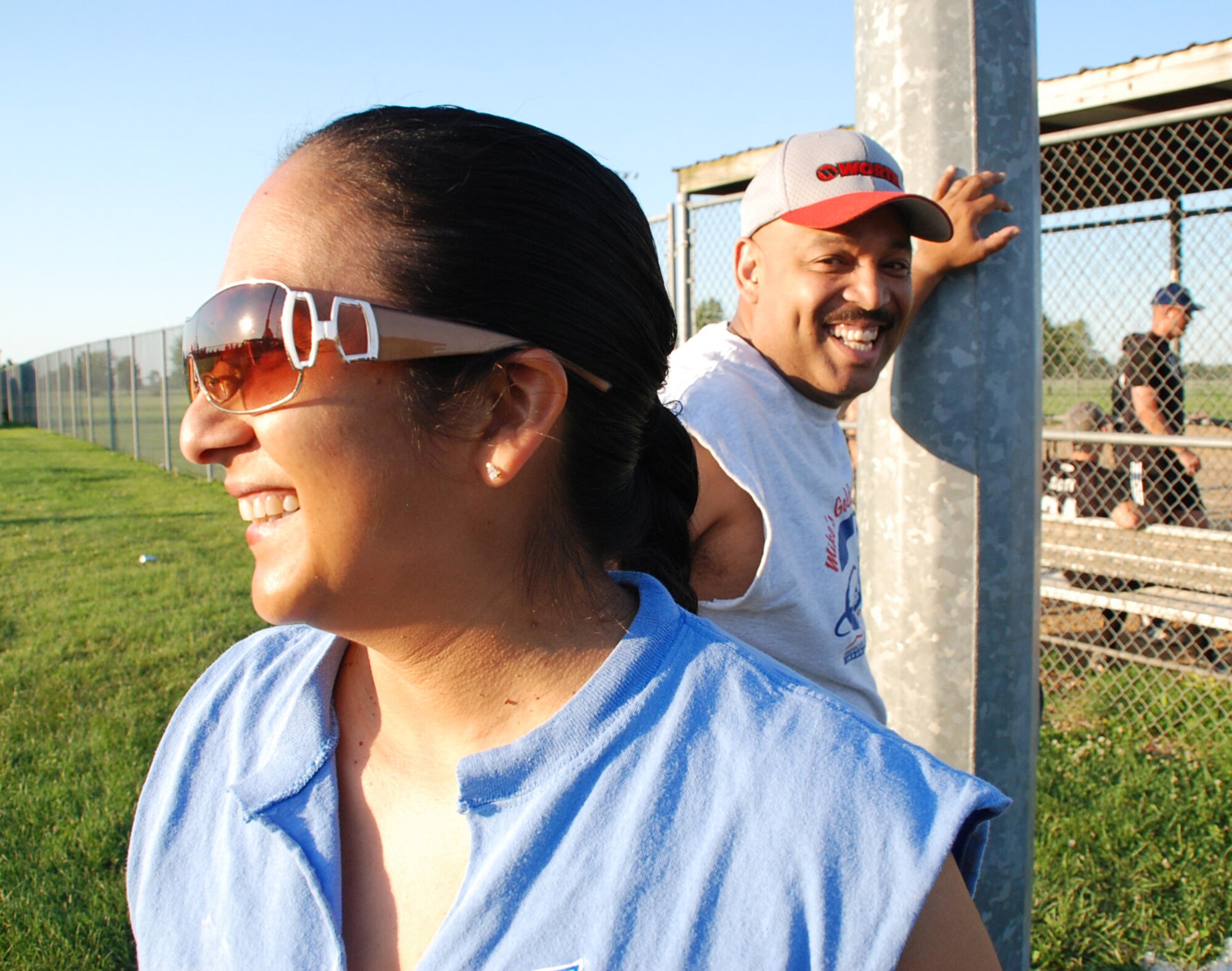 932nd Airlift Wing softball members and husband and wife team Master Sgt. Terri Ray and "DJ" Ellis smile as the prepare to do friendly softball battle with the security forces team.  Despite a hard fought game, the security forces team won in the end.  Photo/Maj. Stan Paregien