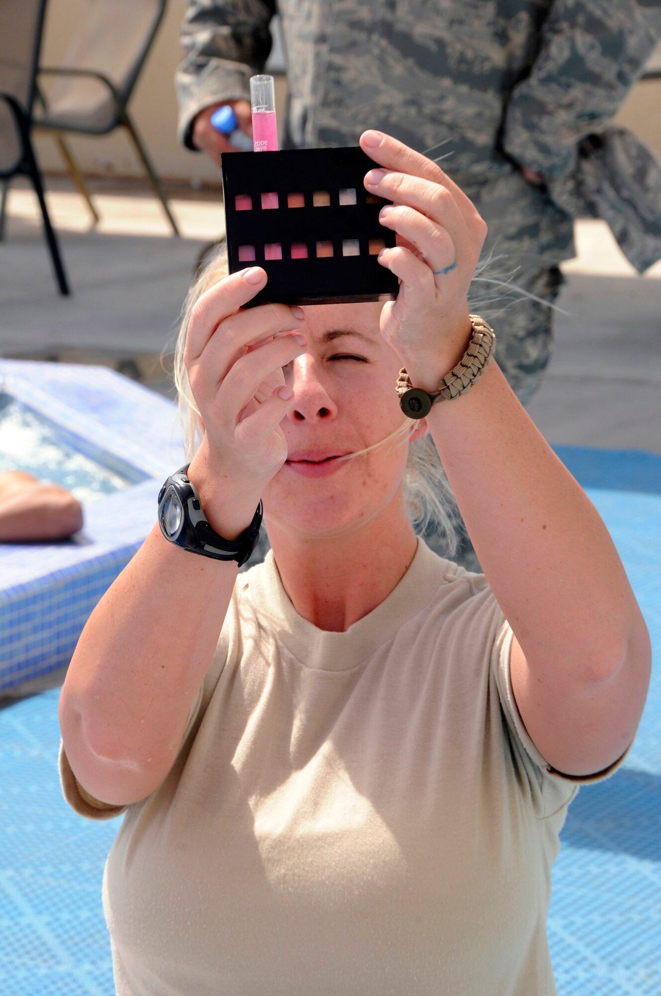 Staff Sgt. Ashlie Steele, a 379th Expeditionary Medical Group bioenvironmental engineer at an air base in Southwest Asia, tests the chlorine in a water sample taken from a base pool. (U.S. Air Force photo/Senior Airman Domonique Simmons) 