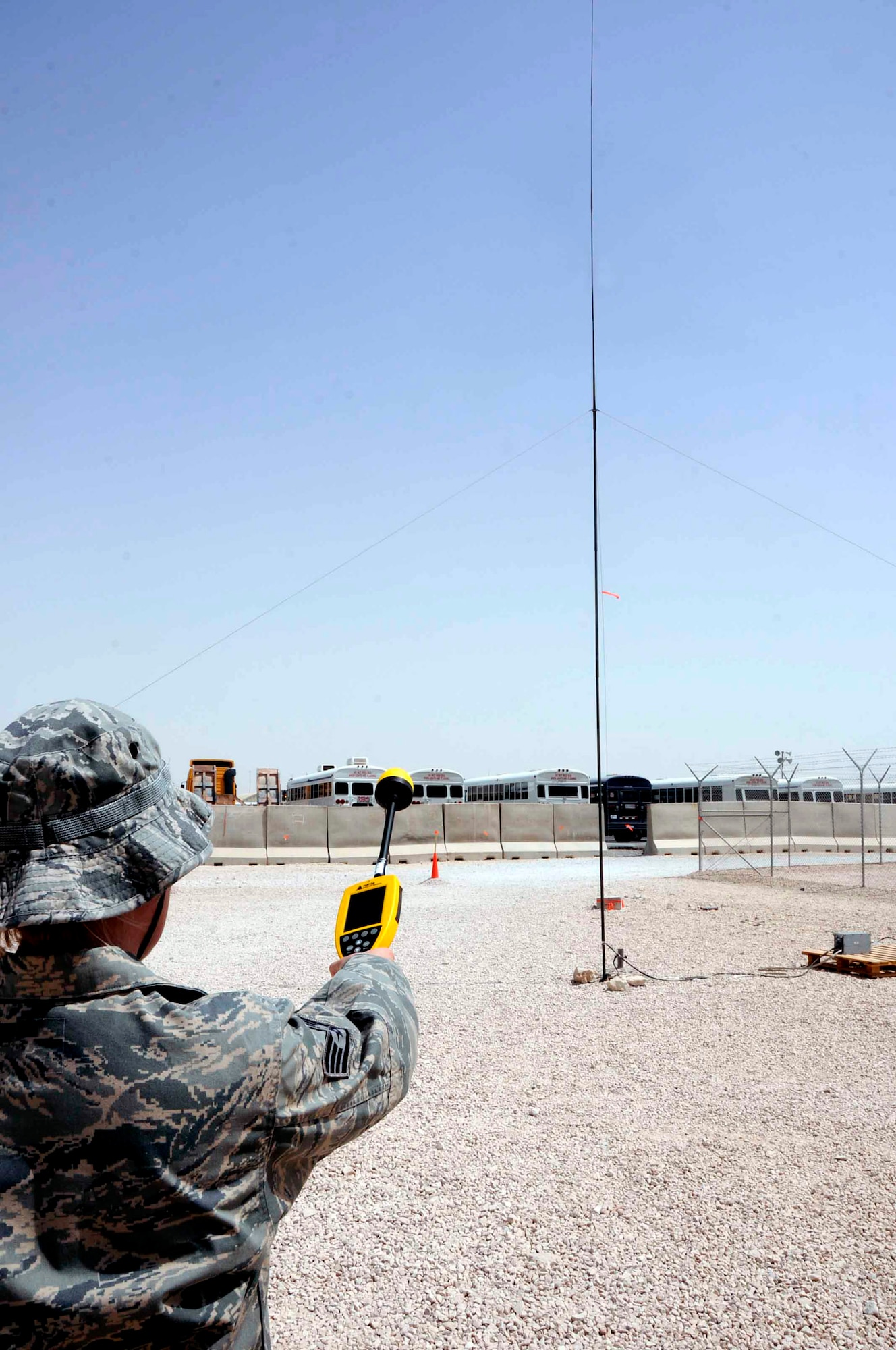 Staff Sgt. Ashlie Steele, a 379th Expeditionary Medical Group bioenvironmental engineer at an air base in Southwest Asia, uses a Narda probe to perform a radio frequency radiation survey.  Sergeant Steele is measuring the RF output of this antenna to ensure it is operating within parameters.  (U.S. Air Force photo/Senior Airman Domonique Simmons) 