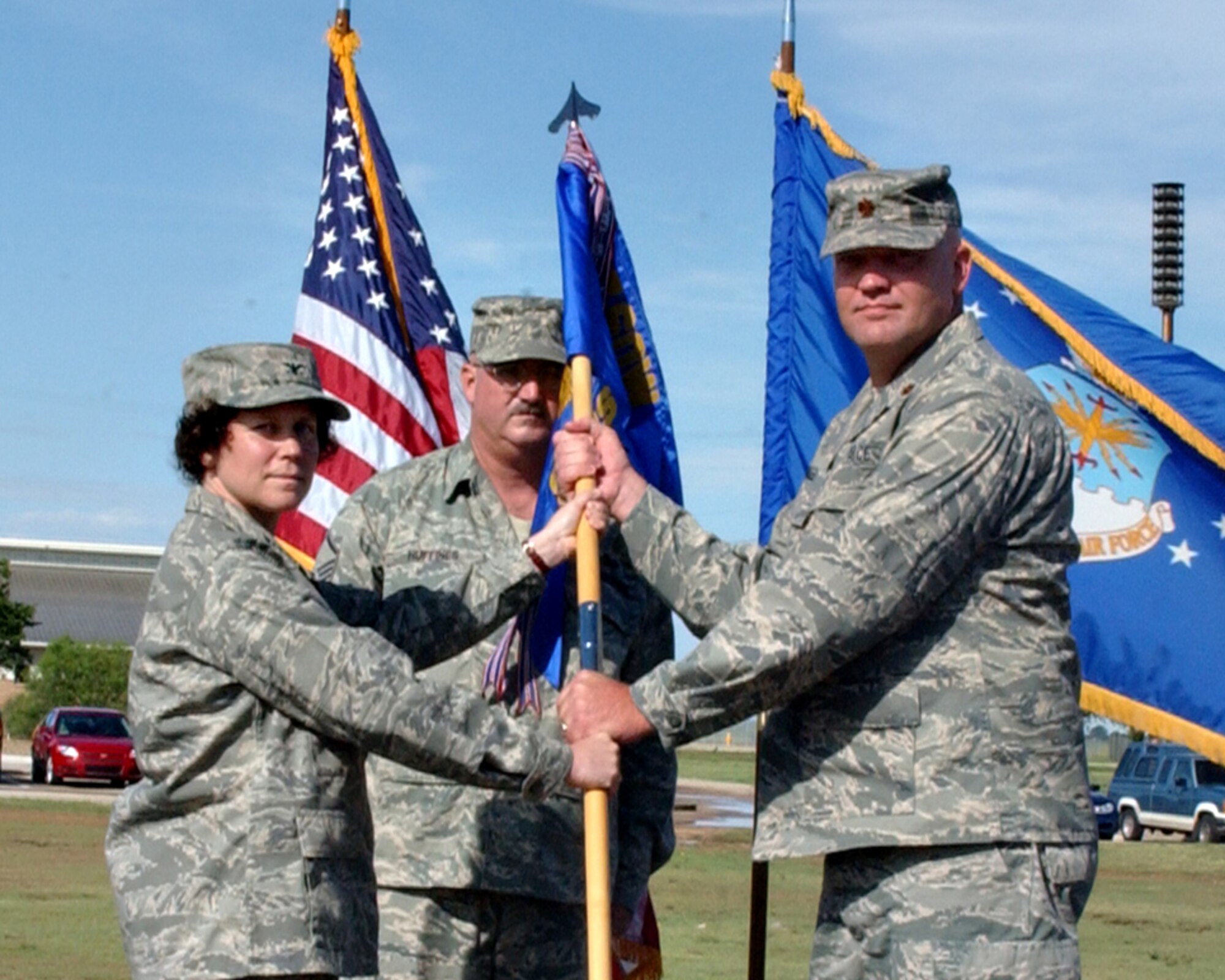 CANNON AIR FORCE BASE, N.M. -- Col. Babette Lenfant, 27th Special Operations Mission Support Group commander, presents the guidon and command of the 27th Special Operations Communications Squadron to Maj. Richard Jarrell in a change of command ceremony July 15. Major Jarrell arrived for duty from Offutt Air Force Base, Neb. The outgoing commander is Lt. Col. Stacy Clements whose next assignment will be in Germany. (U.S. Air Force photo by Beth Merchant)                               