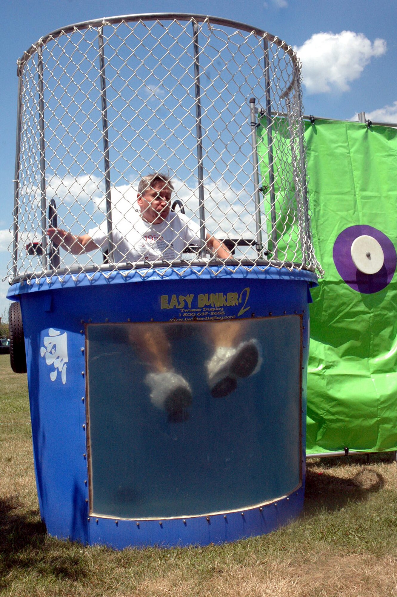 Maj. Gen. Kip Self, U.S. Air Force Expeditionary Center commander, splashes into the dunk tank for the first time during the U.S. Air Force Expeditionary Center picnic July 11, 2008, on Fort Dix, N.J.  General Self and others took turns getting dunked while at the same time they helped raise money for the Expeditionary Center Association.  (U.S. Air Force Photo/Tech. Sgt. Scott T. Sturkol)
