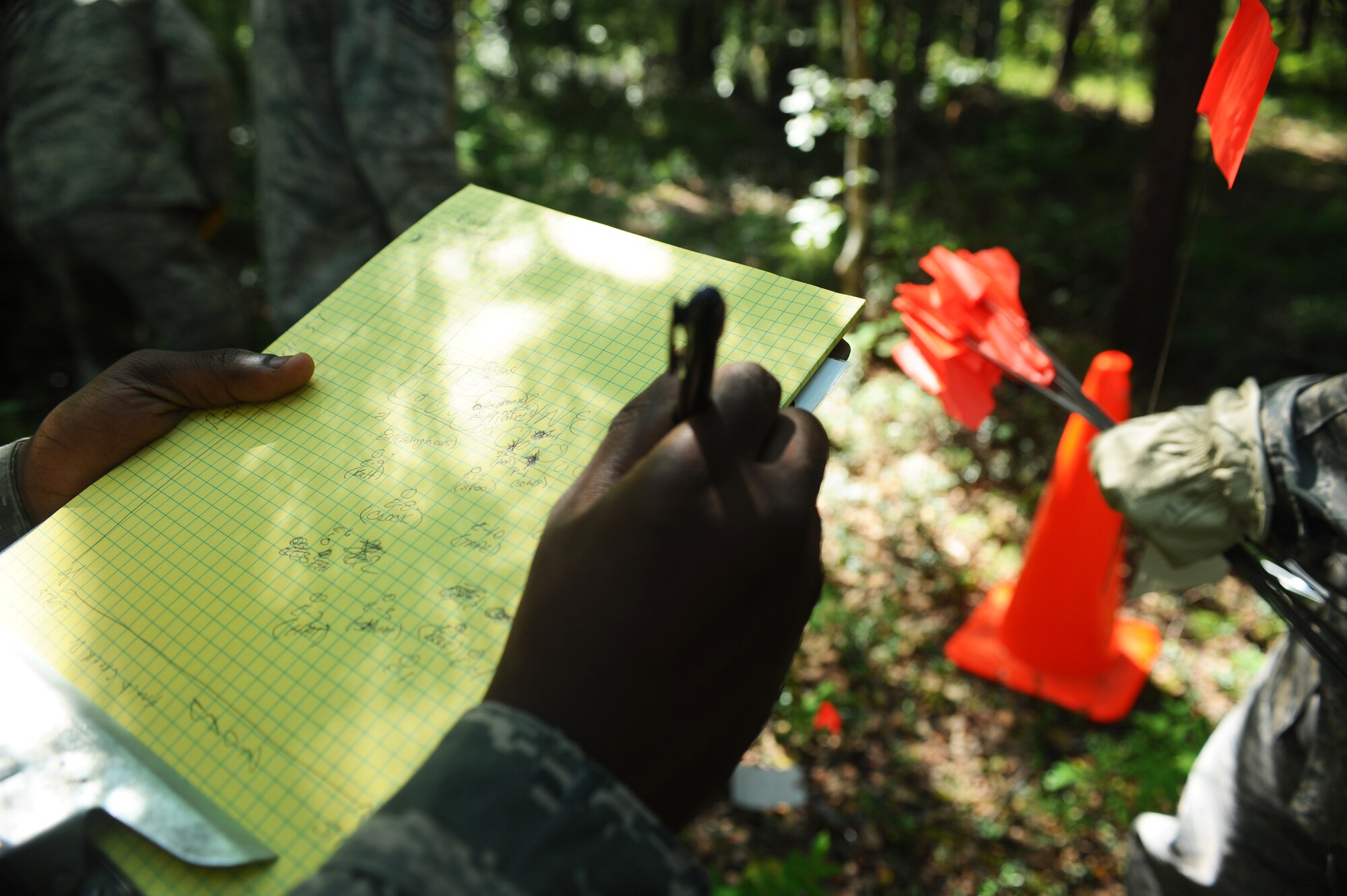Airman 1st Class Brandon Johnson role in the emergency management exercise is plotter within the search and recovery team. His responsibilities include marking down the exact location of all evidence on a grid during the search and recovery exercise July 15, 2008 at Eielson Air Force Base, Alaska. Airman of Force Support Squadron form a single line and step in unison covering ground while searching for any evidence that will be needed to be marked and plotted. (U.S. Air Force Photo/Airman 1st Class Jonathan Snyder) (Released)