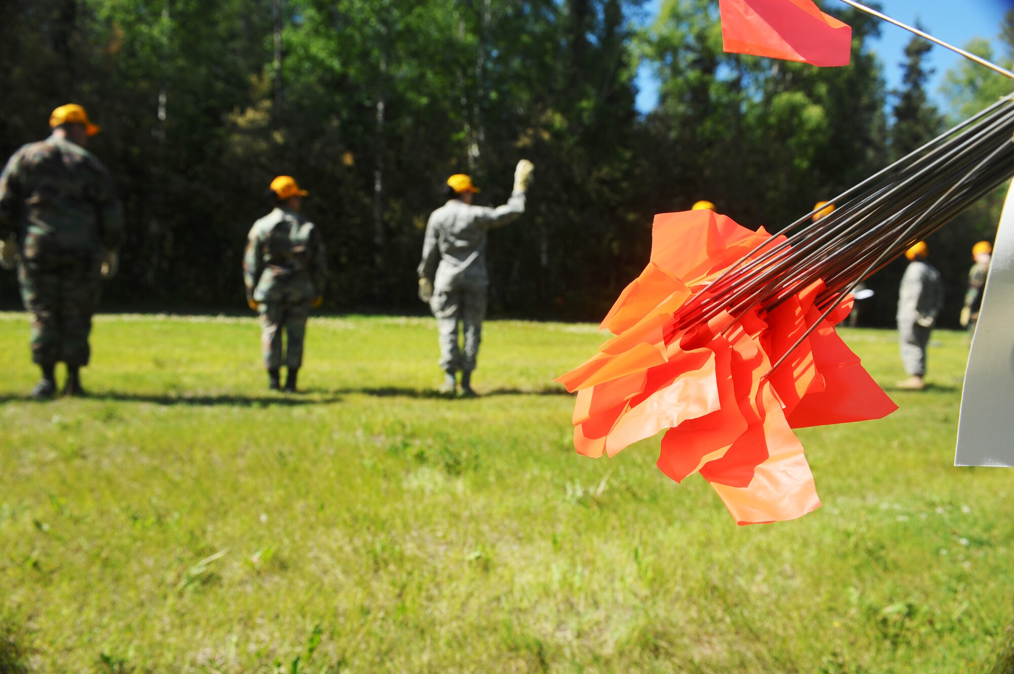 Airman 1st Class Claudia Arce signals that she has found something during search and recovery exercise July 15, 2008 at Eielson Air Force Base, Alaska. 354th Force Support Squadron Airmen form a single line and step in
unison covering ground while searching for any evidence that will be needed to be marked and plotted. (U.S. Air Force Photo/Airman 1st Class Jonathan Snyder) (Released)