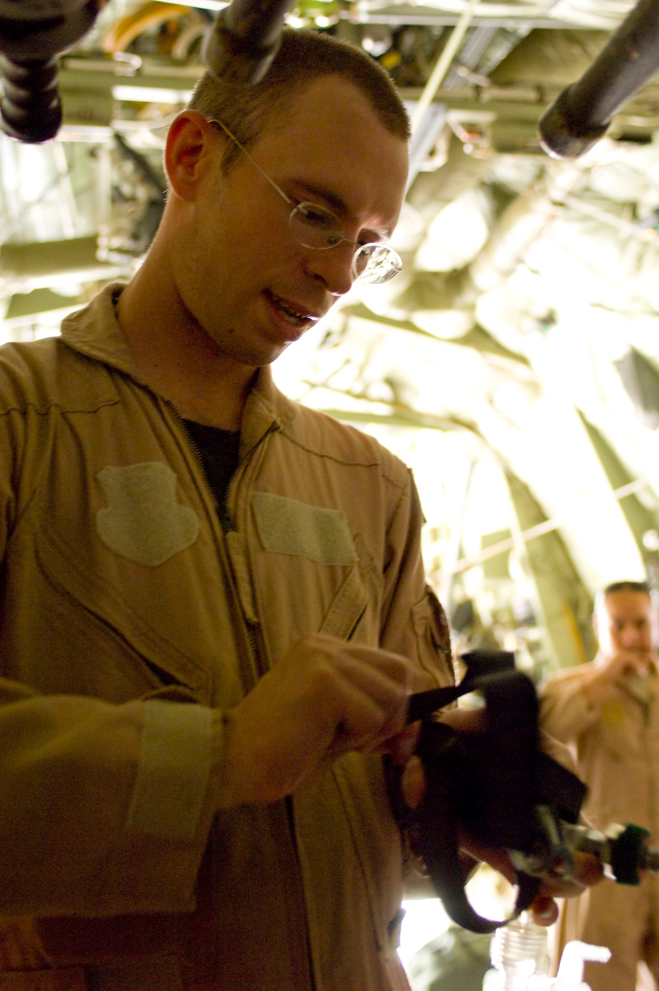 Capt. Matthew Rist hooks up oxygen in a C-130 Hercules July 8 at Bagram Air Field, Afghanistan. Captain Rist, a member of the 455th Expeditionary Aeromedical Evacuation Flight, prepared the medical supplies during the C-130's conversion for an aeromedical evacuation mission. The team is deployed from the 375th Aeromedical Evacuation Squadron at Scott Air Force Base, Ill. (U.S. Air Force photo/Staff Sgt. Samuel Morse) 
