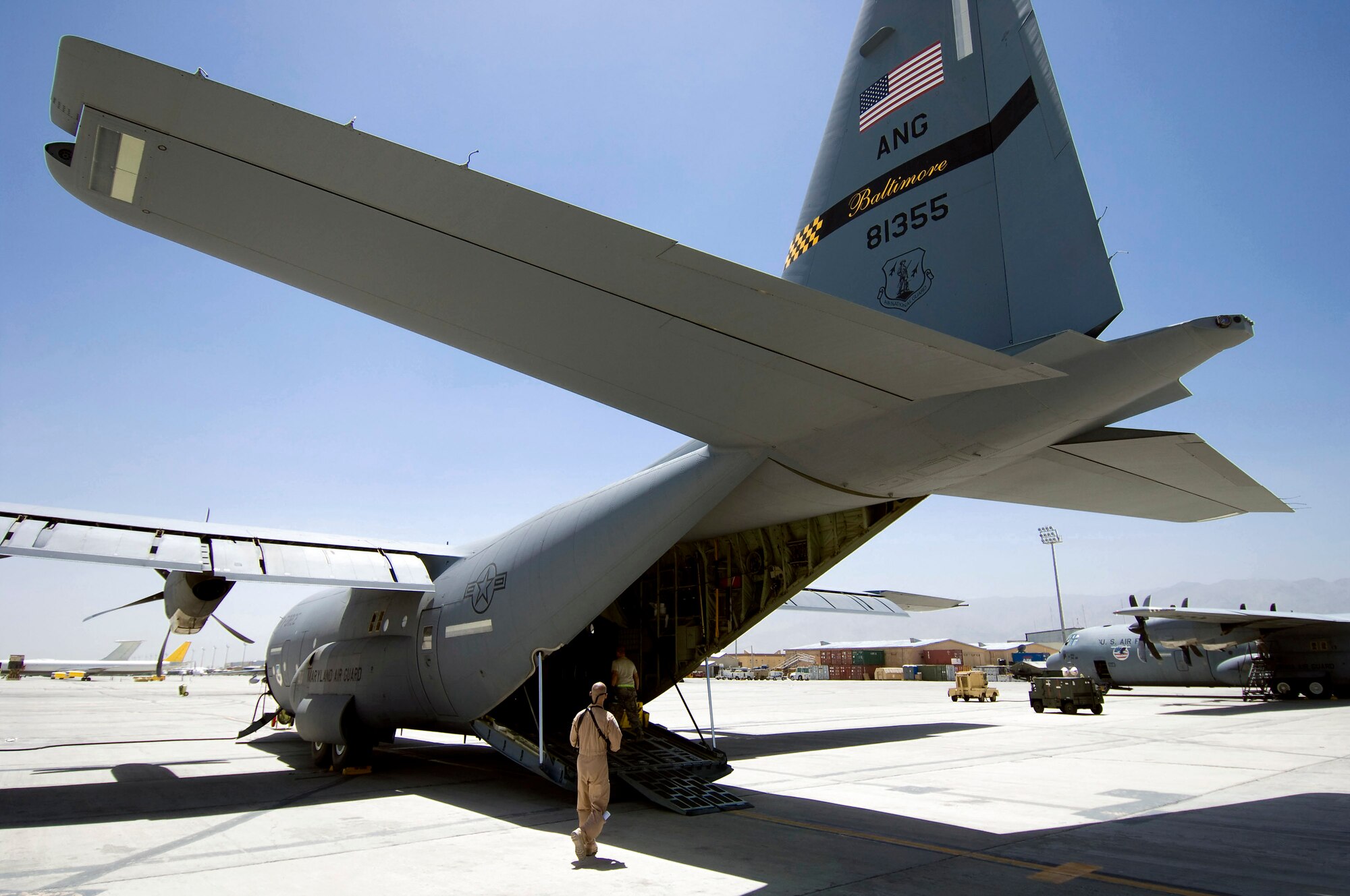 An Air National Guard C-130 Hercultes from Baltimore, Md., sits on the tarmac July 8 at Bagram Air Field, Afghanistan. Members of the 455th Expeditionary Aeromedical Evacuation Flight work to quickly convert the aircraft for an aeromedical evacuation. (U.S. Air Force photo/Staff Sgt. Samuel Morse) 
