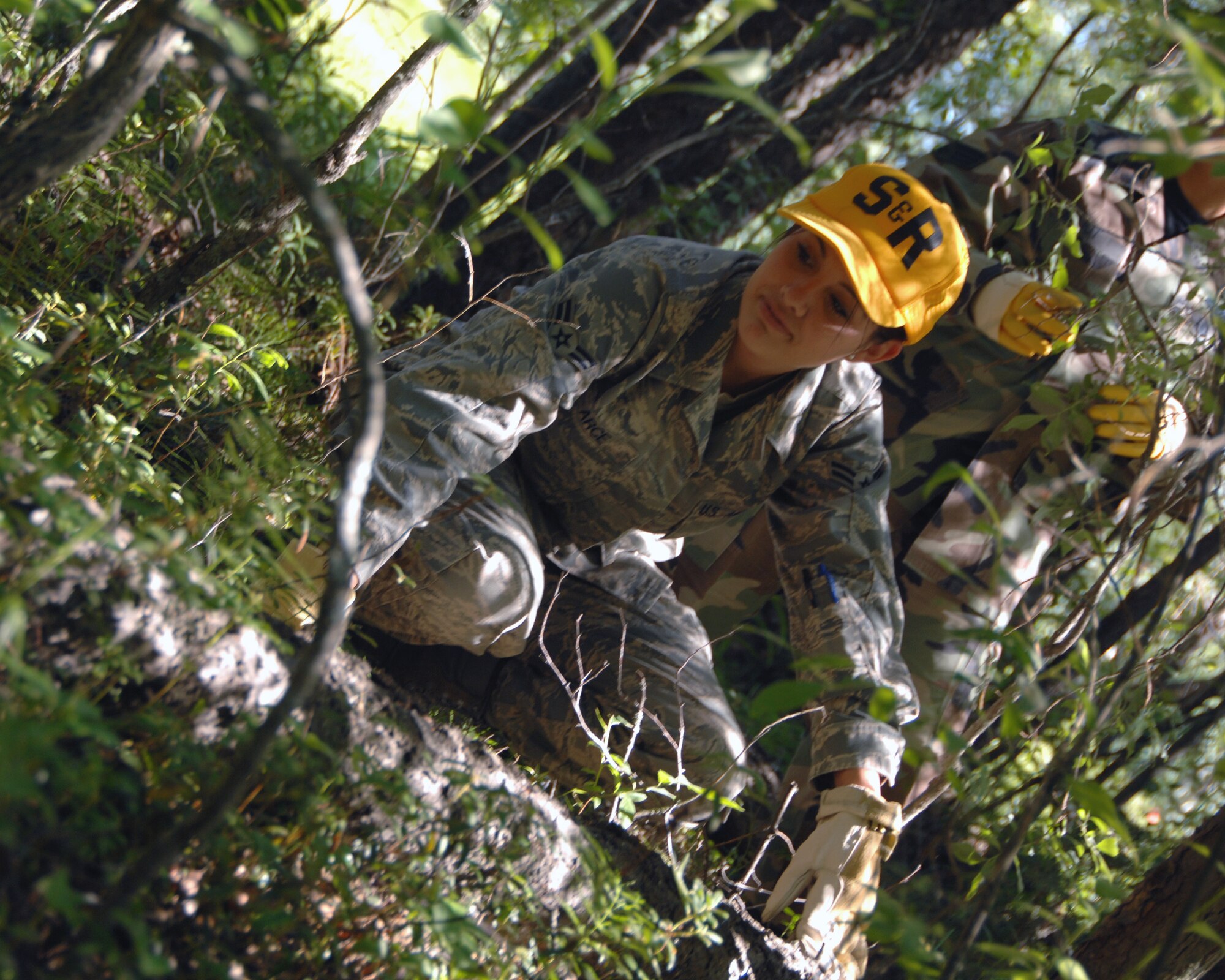 Airman 1st Class Claudia Arce, 354th Force Support Squadron emergency response search and recovery team, conducts a sweep of a simulated aircraft mishap during a search and recovery exercise July 15, 2008. The exercise was designed to provide a realistic aircraft crash training scenario for emergency teams.  (U.S. Air Force photo/Staff Sgt. Tia Schroeder)