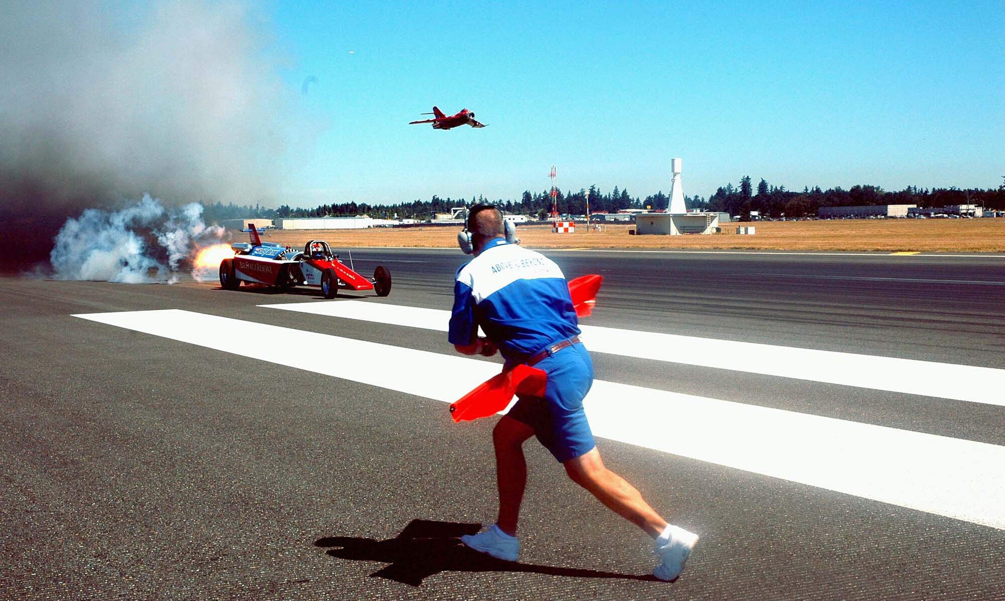 Air Force Reserve jet car crew chief Bill Braack signals his driver, Scott Hammack, to start the race at the 2005 McChord Air Force Base Expo. The Smoke and Thunder jet car show will appear again at McChord during the 2008 McChord Air Expo July 19-20. The air expo is free and open to the public, featuring numerous displays, static aircraft, and aerial demonstrations, to include the U.S. Air Force Thunderbirds precision aerial demonstration team. (U.S. Air Force file photo/Tech. Sgt. Nick Przybyciel)