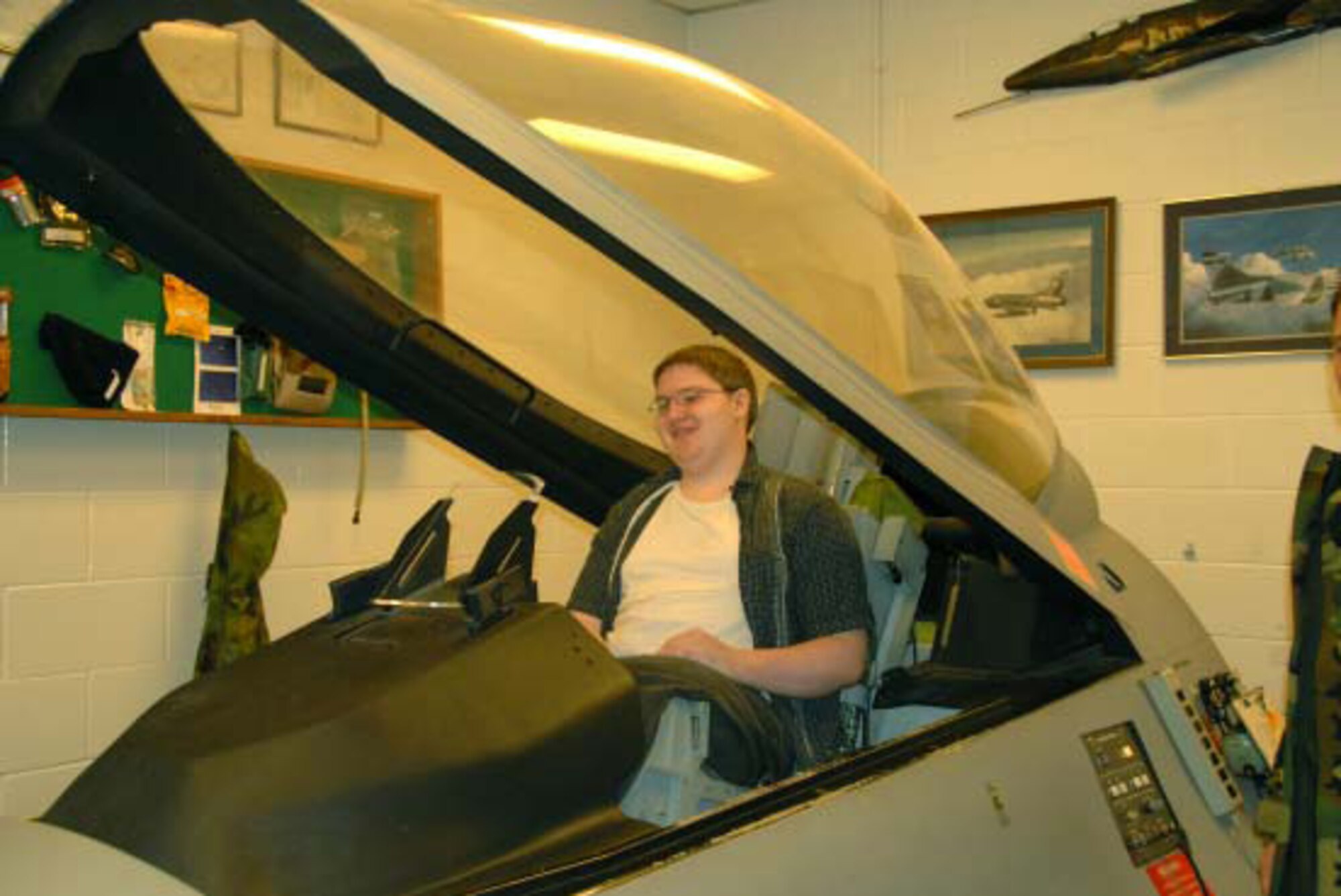 Scott Ricard of Findlay, Ohio, checks out the F-16 simulator during his tour of
the 180th Fighter Wing May 6.