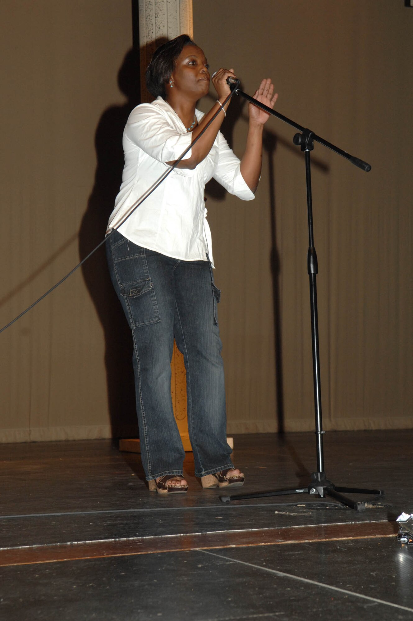 Second place winner, Staff Sgt. Sonya Nelson, 355th Maintenance Operations Squadron plans and scheduling technician, performs her first song of the evening at the first annual D-M Idol competition held July 11 at the Tucson Magnet High School Auditorium. Sergeant Nelson, a native of South Carolina, lists Luther Vandross, Tony Bennet, Lauren Hill and Jill Scott as her favorite singers. The event was hosted by the First Six organization and the Culture of Responsible Choices committee. (U.S. Air Force Photo By Senior Airman Melissa Copeland)