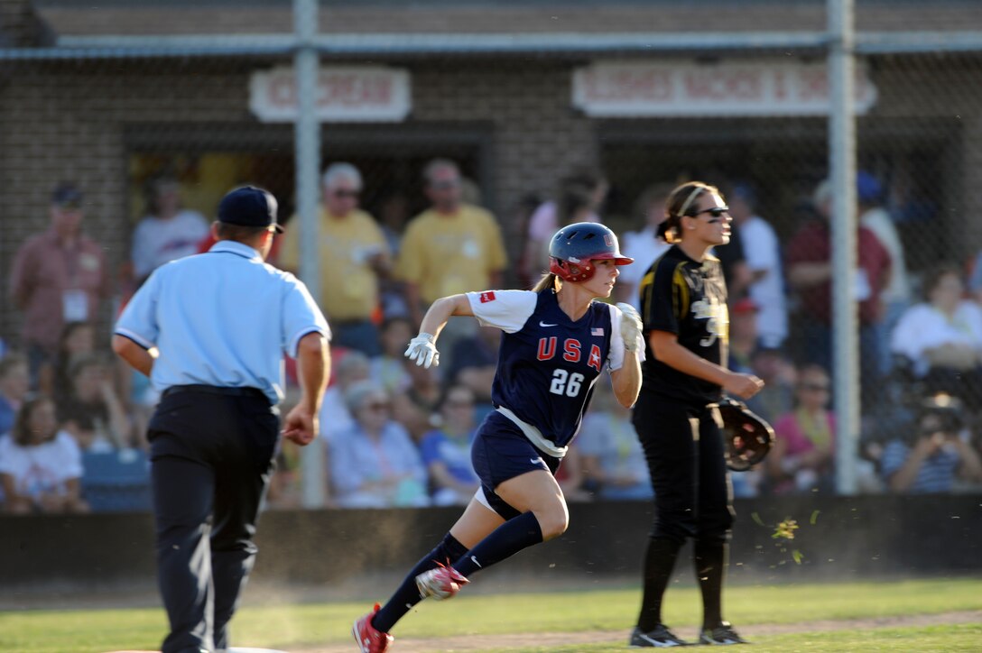 Caitlin Lowe (center), U.S.A. Olympic Softball team outfielder, rounds first base and heads to second legging out a double at the Pete Lien Memorial Field, Rapid City, S.D., July 15. More than 200 fans attended the game. (U.S. Air Force photo/Senior Airman Kasey Zickmund)