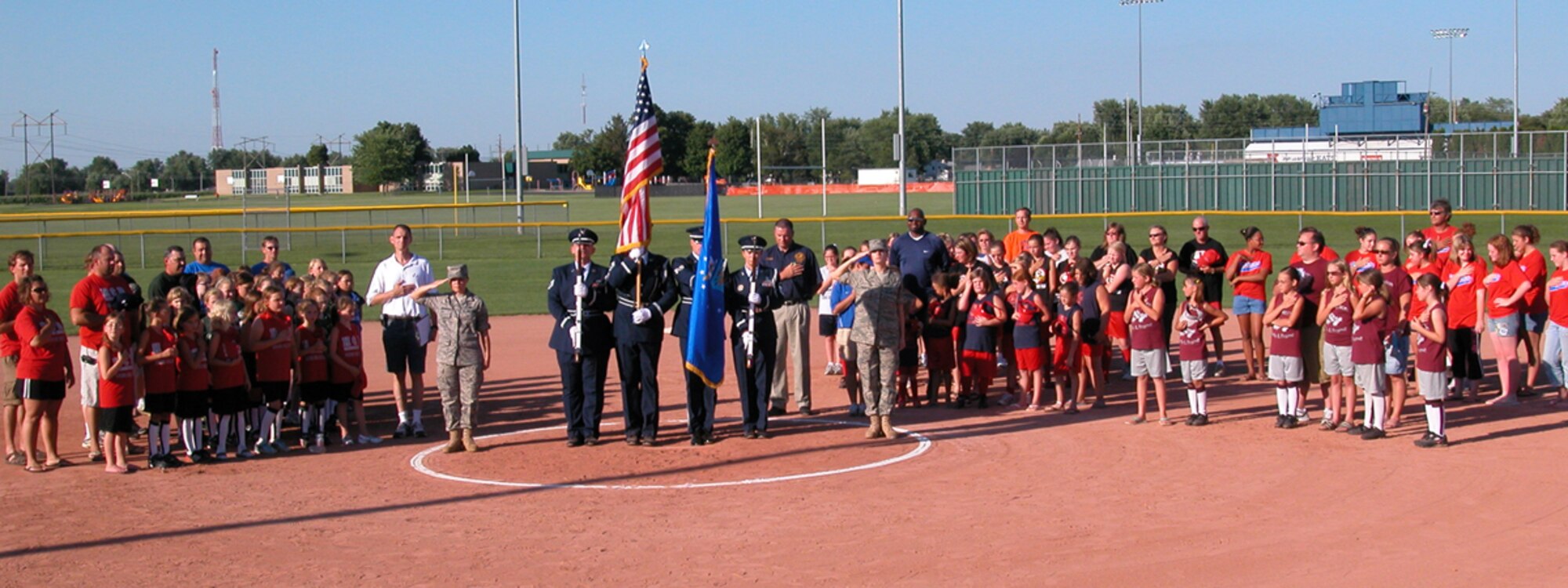 GRISSOM AIR RESERVE BASE, Ind., -- Members of the 434th Air Refueling Wing Honor Guard, along with Airmen from the 434th ARW Seasoning Flight post the colors and salute during the opening ceremonies of the final game of the Kokomo girls softball season. (U.S. Air Force photo/Airman Basic Edward Lawton)
