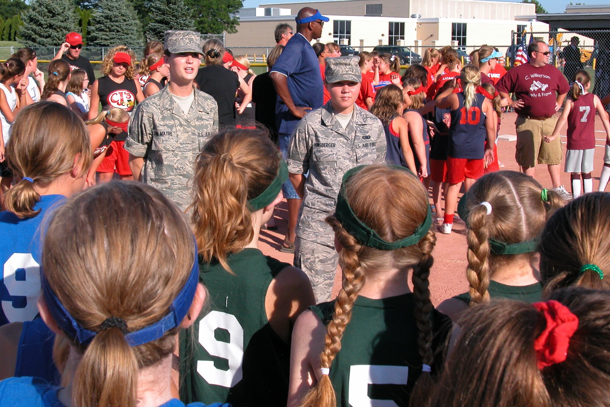 GRISSOM AIR RESERVE BASE, Ind., -- Airman Basic Erica Van Matre, 434th Maintenance Squadron, left, and Airman Basic Lindsey Hunsberger, 434th Logistics Readiness Squadron, address girls of the Kokomo girls' softball league recently. The two Airmen are assigned to Grissom and currently undergoing training under the seasoning training program. In addition to the Airmen, members of the 434th Air Refueling Wing Honor Guard were on hand to post the colors for the final day of play. (U.S. Air Force photo/Airman Basic Edward Lawton)