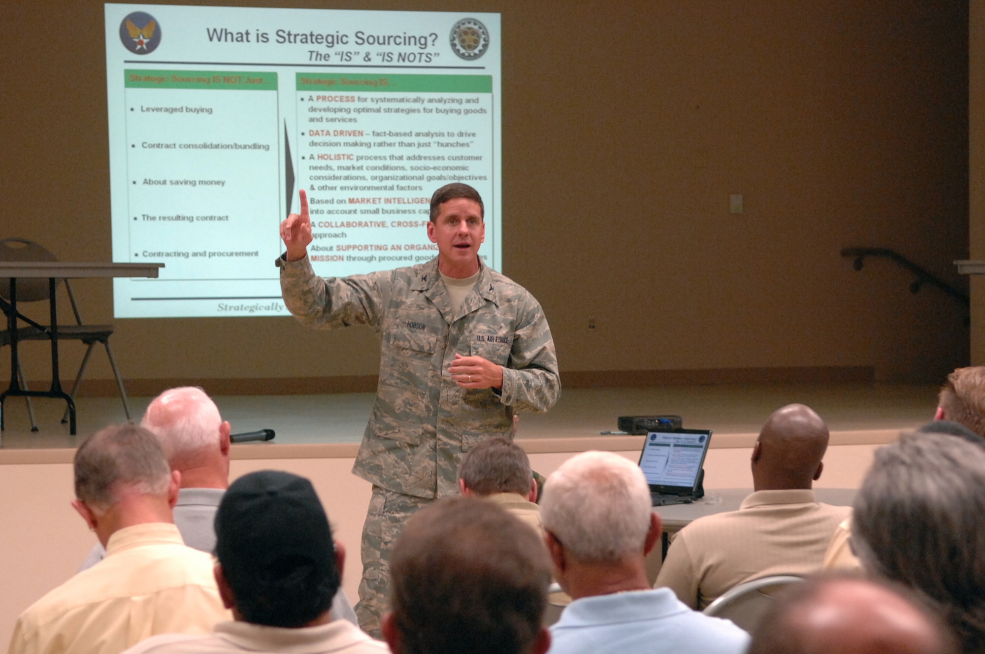 Col. Mark Hobson, Headquarters Air Force Materiel Command Directorate of Contracting Resource Management Division chief, talks to local business owners about how the upcoming Installation Acquisition Transformation will affect how they do business with Nellis Air Force Base during a town hall meeting at the Dr. William C. Pearson Community Center in Las Vegas, Nev., July 14, 2008. Colonel Hobson explained how the transformation would occur and then took questions from the audience regarding their concerns over the changes.  (U.S. Air Force photo / Senior Airman Kasabyan D. Musal)