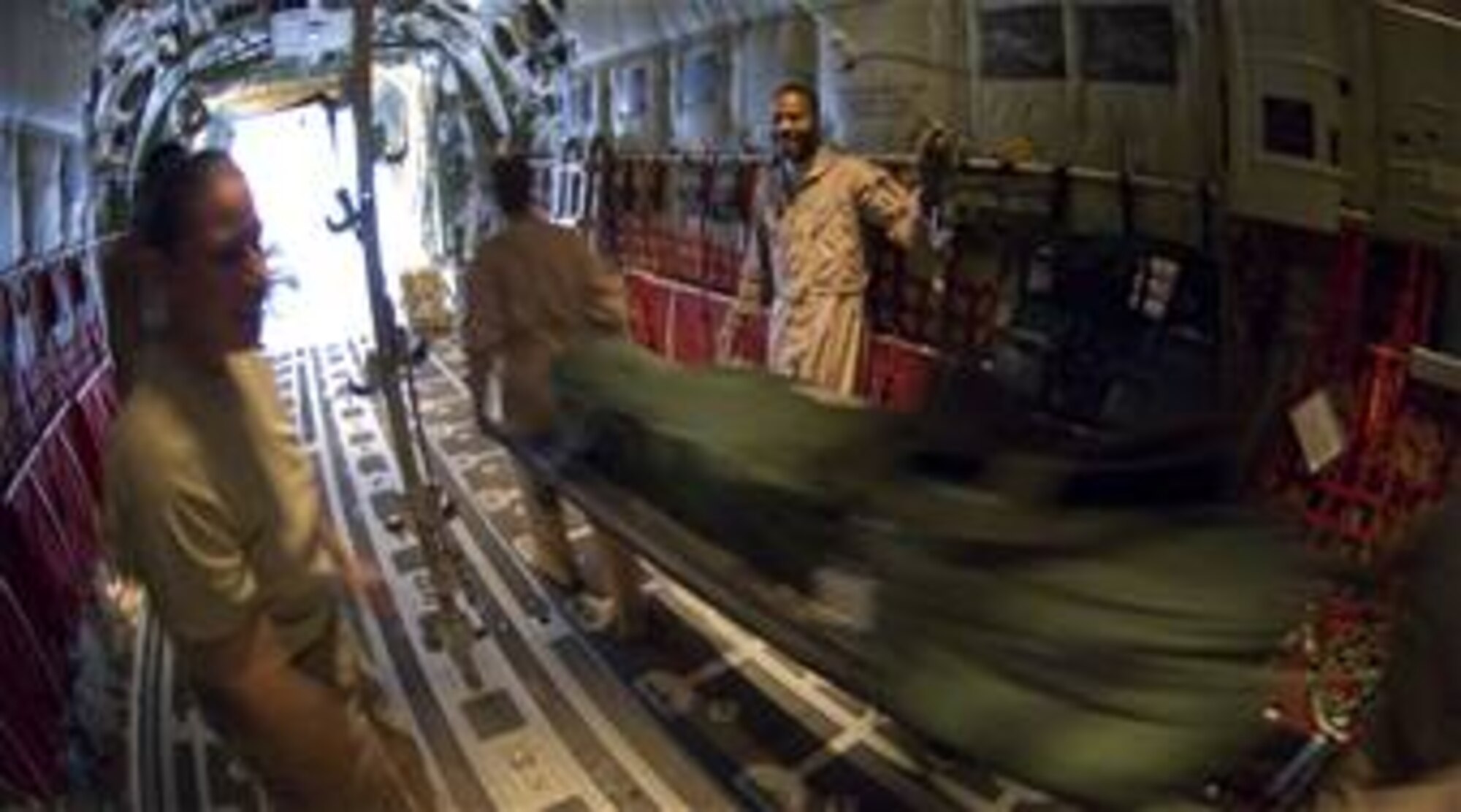 Members of the 155th Expeditionary Aeromedical Evacuation Flight unload an unused litter stacked with medical supplies from a C-130 Hercules.
(photo/Staff Sgt. Samuel Morse)
