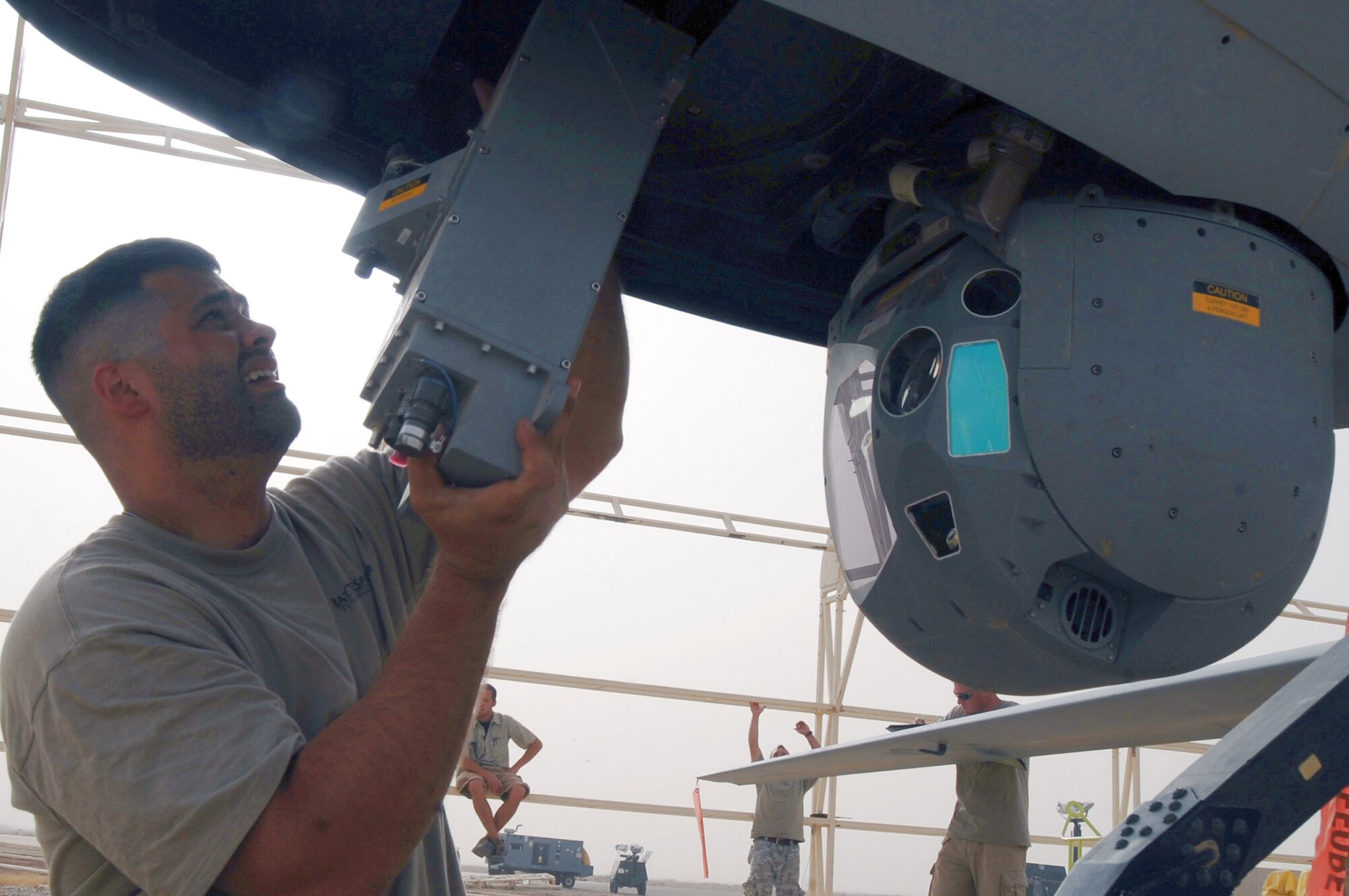 Schuyler Dunn replaces a part of the Multispectural Targeting System Ball on an MQ-1B Predator unmanned aircraft July 9 at Ali Base, Iraq. Through the use of advanced capabilities, focused doctrine and detailed training, the Predator provides integrated and synchronized close air combat operations, to include intelligence, surveillance and reconnaissance.  Mr. Dunn is an aircraft technician with the 361st Expeditionary Reconnaissance Squadron aircraft technician. (U.S. Air Force photo/Tech. Sgt. Sabrina Johnson) 