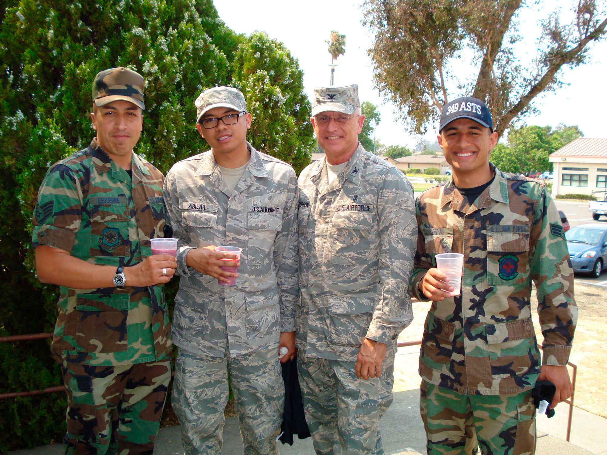 Staff Sgt. Anthony LeGuerre, Senior Airman Abraham Abilar and Senior Airman Gabriel Rendon, all Airmen from the Aeromedical Staging Squadron, visit with guest speaker Col. Jim Patterson, 932nd Medical Group Commander, Scott Air Force Base, Illinois after the First Term Airmen's Call, July 12 at Travis Air Force Base, Calif. (U.S. Air Force photo by Staff Sgt. Meredith Mingledorff) 