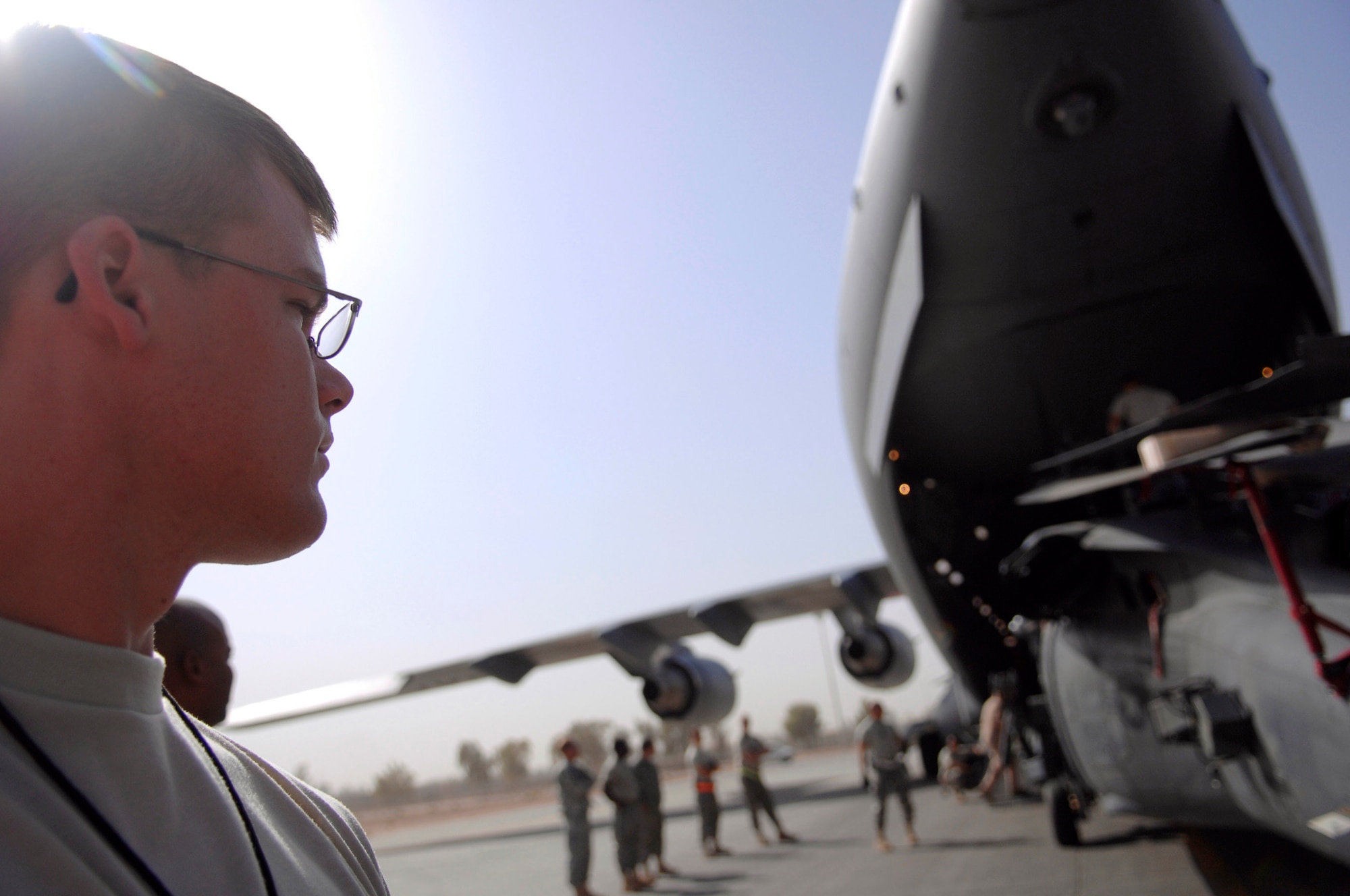 Airman 1st Class John Rhoades stands by as an HH-60 Pave Hawk is loaded onto a C-17 Globemaster III July 12 at Joint Base Balad, Iraq. Several Airmen position themselves around the helicopter to ensure it doesn't make contact and cause damage. The helicopter is being rotated back to Moody Air Force Base, Ga., for overhaul maintenance. Airman Rhoades is a 64th Expeditionary Helicopter Maintenance Unit avionics specialist deployed from Davis-Monthan Air Force Base, Ariz. (U.S. Air Force photo/Senior Airman Julianne Showalter) 