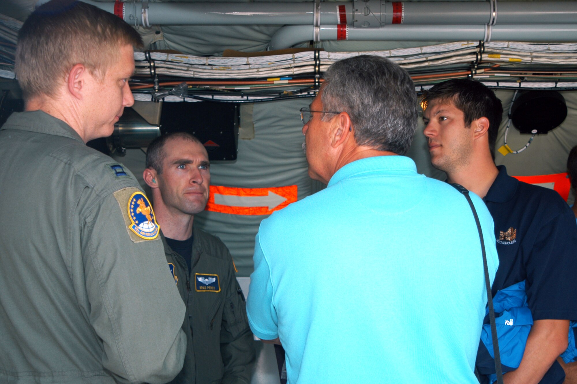 GRISSOM AIR RESERVE BASE, Ind., -- Aircrew members from the 72nd Air Refueling Squadron, Capts. Ladd Leimer, left, and Brad Percy, talk with Mr. Tyler Silveus, right, and Mr. John Urschalitz prior to departing on an aerial refueling mission. The two were a part of a group of civic and business leaders from the Warsaw, Ind., region who spent the day at Grissom learning about the base, and its KC-135R Stratotanker mission. (U.S. Air Force photo/Capt. Kelly Howard)