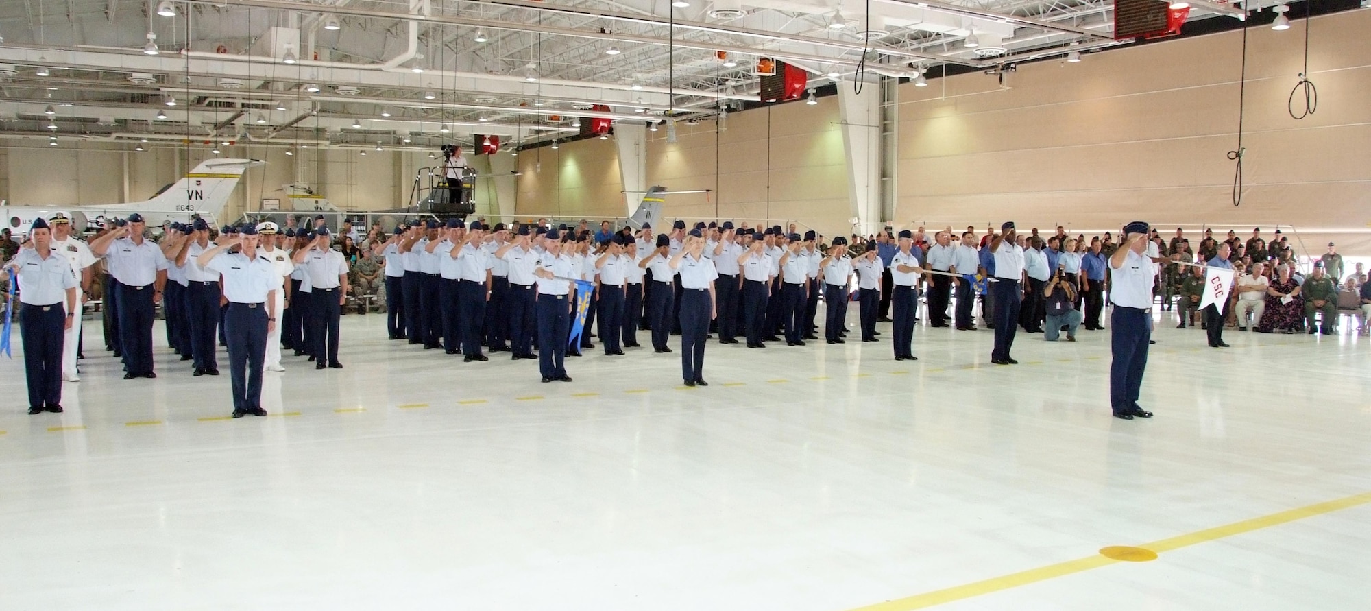 Members of Team Vance render a salute during the 71st Flying Training Wing change of command ceremony held July 11 in Hangar 199 at Vance AFB, Okla. The four elements represented the 71st Operations Group, the 71st Medical Group, the 71st Mission Support Group and Computer Sciences Corporation, the primary contractor at Vance AFB. Col. Mark. C. Nowland assumed command of the 71st FTW. (U.S. Air Force photo by Terry Wasson)