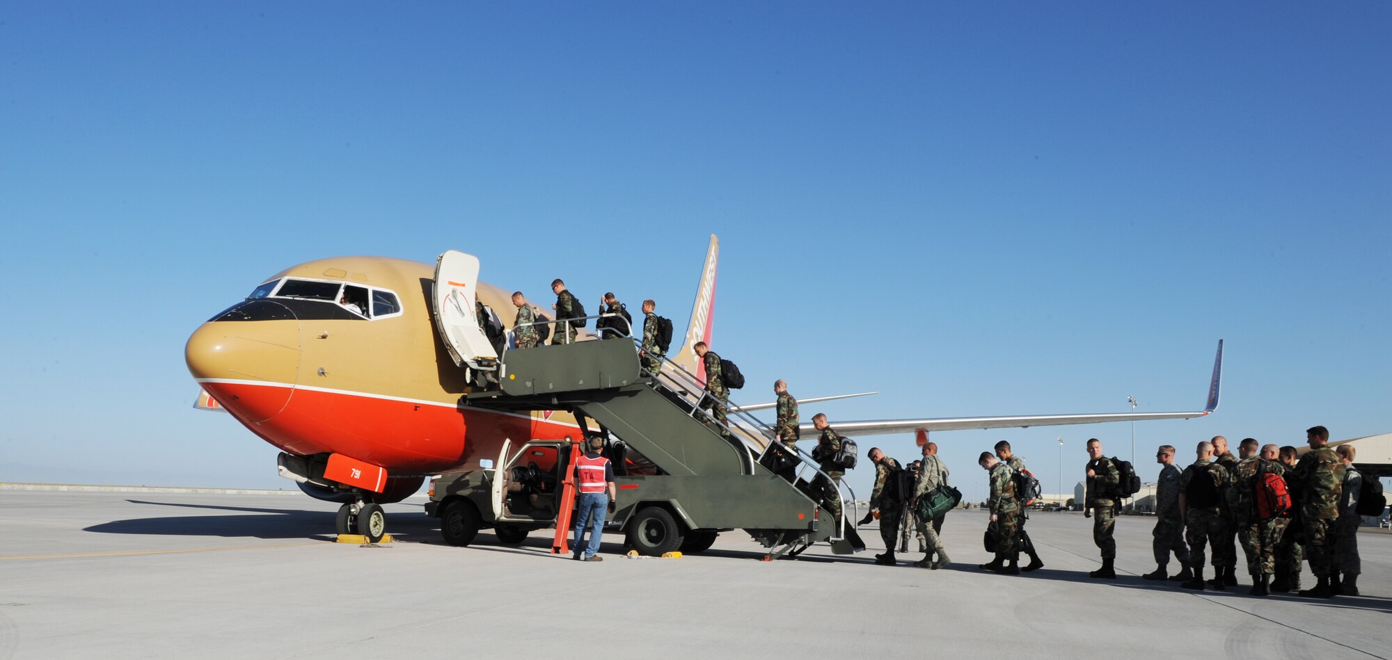 MOUNTAIN HOME AIR FORCE BASE, Idaho -- Members of the 366th Fighter Wing board a Southwest Airlines aircraft, July 10. More than 200 Airmen departed here July 10 to take part in a two-week, joint-mission and joint-force exercise, known as Green Flag, at Nellis AFB, Nevada.  (U.S. Air Force photo/ Airman 1st Class Stephany Miller)