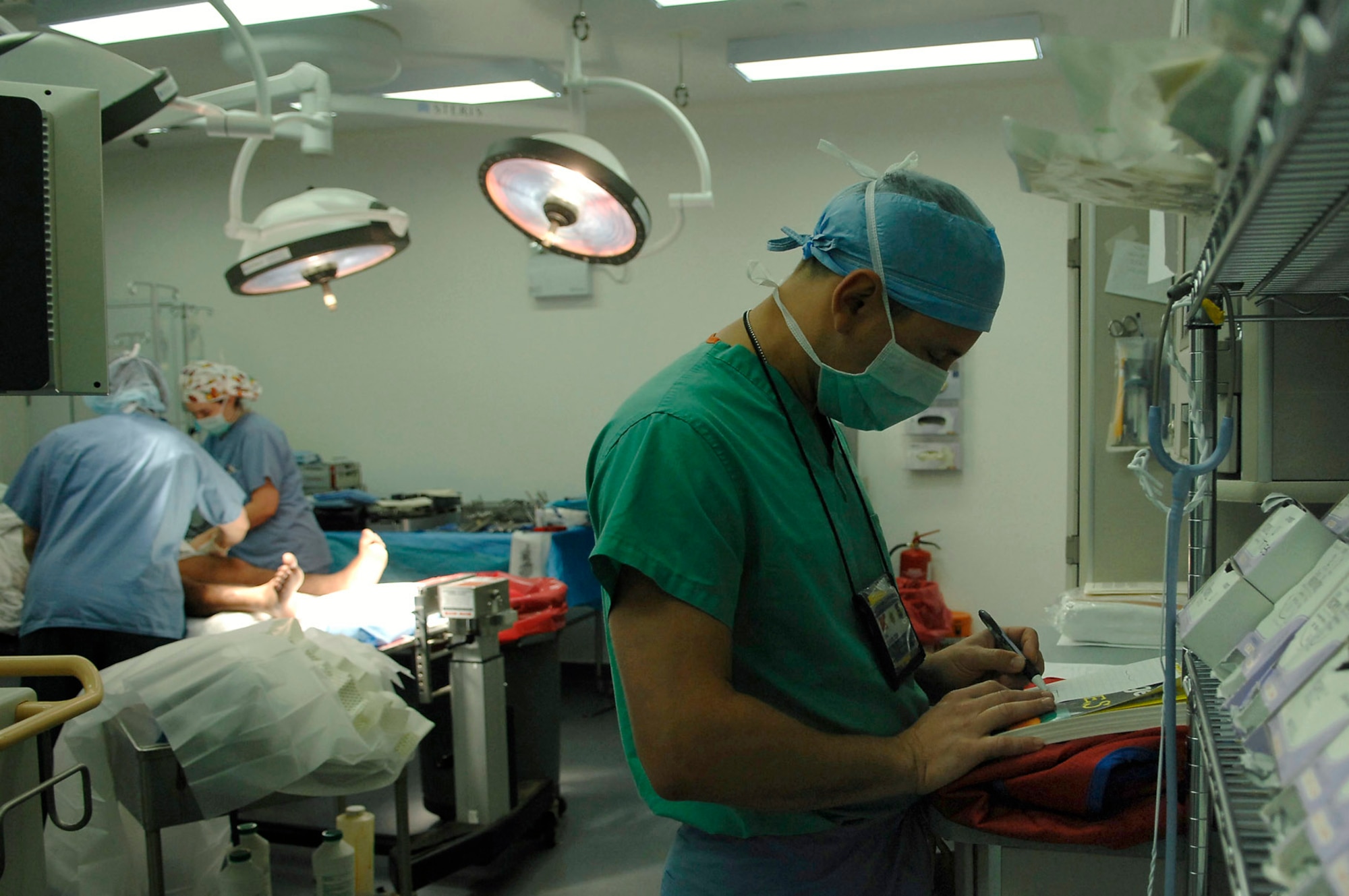 Maj. (Dr.) Michael Charlton draws out a procedure plan before commencing surgery July 2 at Joint Base Balad, Iraq. A new rod and screws, along with a bone graft taken from the patient's hip, will be used to correct an injury that has not healed properly. The corrective surgery should allow the patient to walk again. Doctor Charlton is a 332nd Expeditionary Medical Operations Squadron orthopedic trauma surgeon deployed from Lackland Air Force Base, Texas. (U.S. Air Force photo/Senior Airman Julianne Showalter) 
