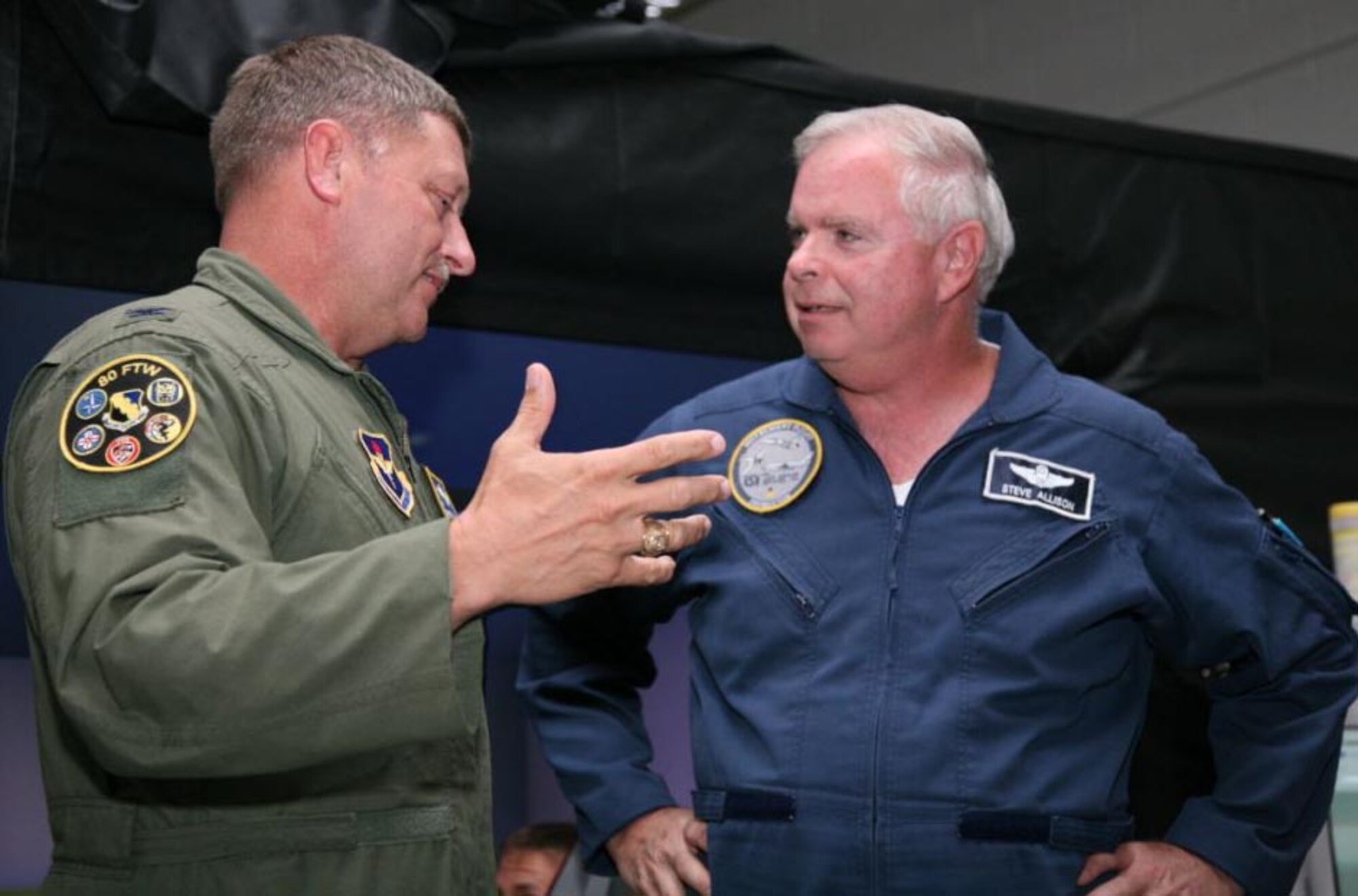 Col. Dan Clark, left, catches up with T-38C simulator instructor Steve Allison July 15 during the colonel's visit to the 80th Flying Training Wing. Mr. Allison was Colonel Clark's flight commander and instructor pilot when the colonel began his Air Force career in 1985 at the Euro-NATO Joint Jet Pilot Training Program. (U.S. Air Force photo/Lt. Col. Ternell Washington)