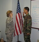 SEYMOUR JOHNSON AIR FORCE BASE, N.C. -- Staff Sgt. Alex Tadeo (right) reenlists in the Air Force Reserve during the July unit training assembly for another six years. Administering the oath of enlistment is 916th Civil Engineer Squadron Commander Lt. Col. Kerri Grimes. Sgt. Tadeo is a pest management craftsman.