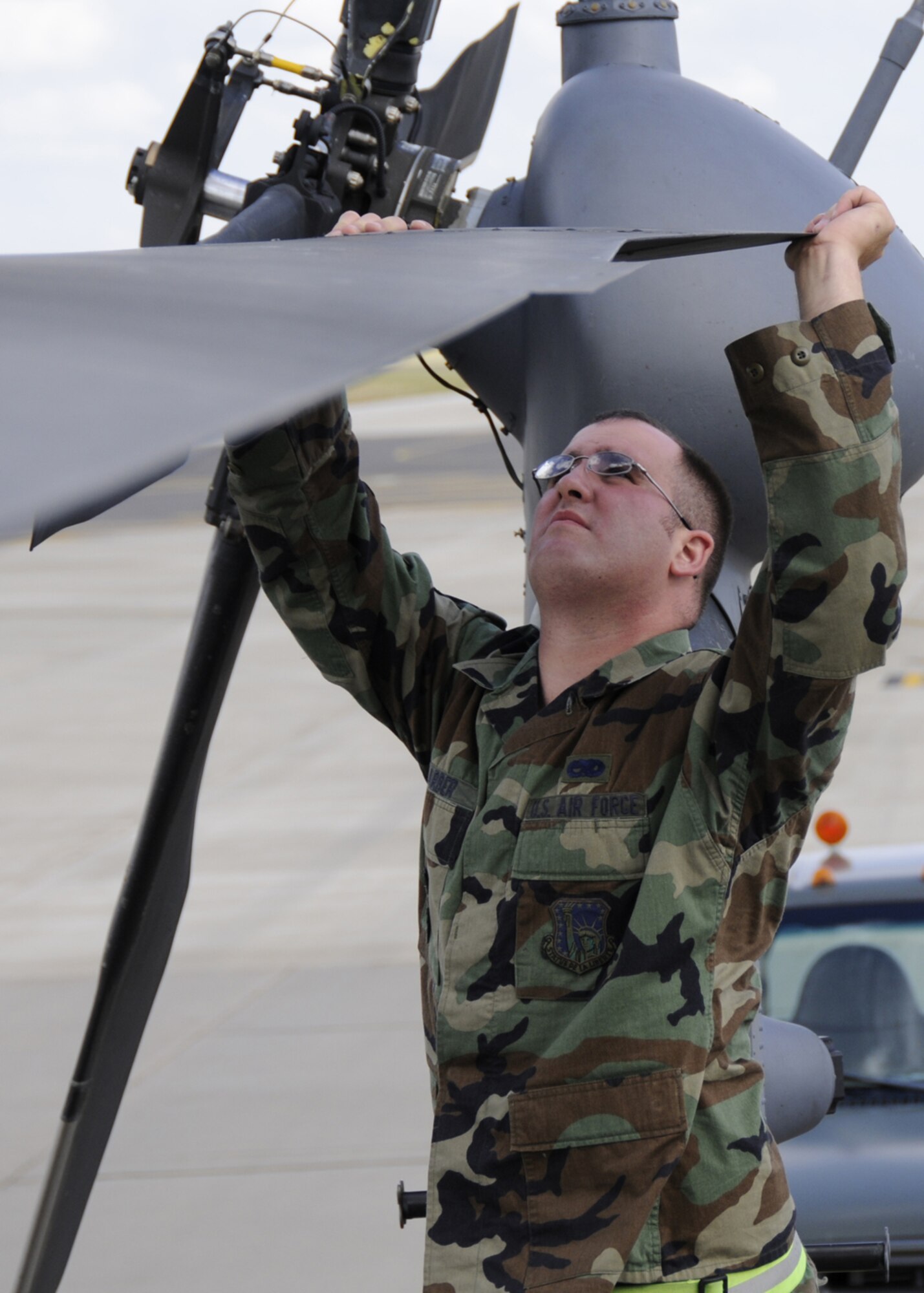 Senior Airman Michael Barber, 48th Aircraft Maintenance Squadron HH-60G helicopter crew chief inspects the main rotor blade for general condition and the abrasion strips for erosion, July 10 at RAF Lakenheath, England. This is one of the tasks included in the pre-flight inspection. (U.S. Air Force photo by Airman Perry Aston) 