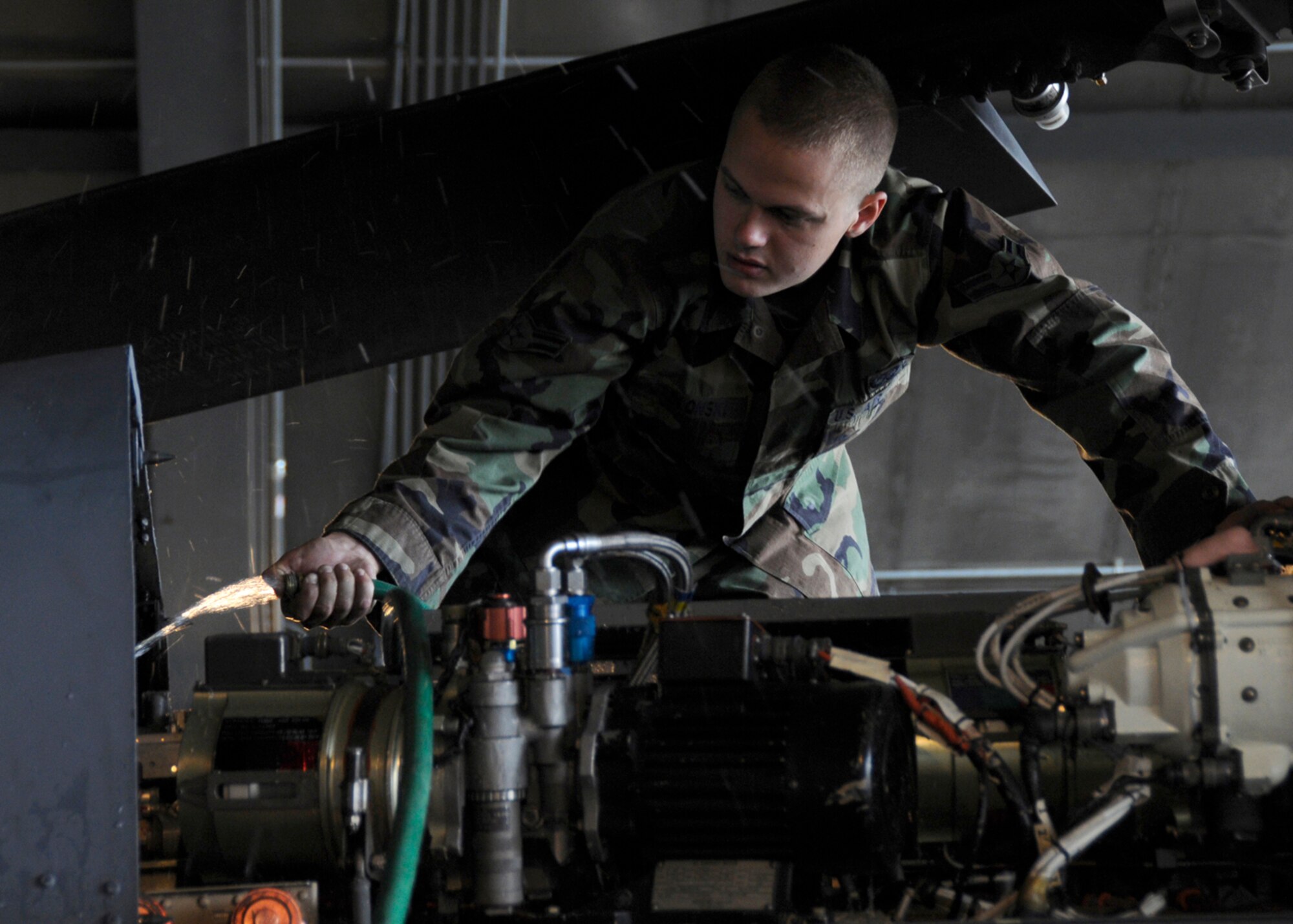 Airman 1st Class Christopher Jablonski, 48th Aircraft Maintenance Squadron HH-60G helicopter crew chief washes off salt on an HH-60G Pave Hawk, July 10 at RAF Lakenheath, Engalnd.  If the Helicopter flies under 3000 feet over salt water, the crew chiefs must wash off any corrosive salt that could have been deposited on the helicopter. (U.S. Air Force photo by Airman Perry Aston) 