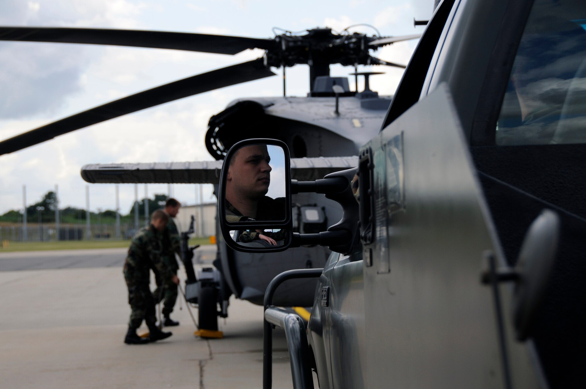 Staff Sgt. Matthew Reihle, 48th Aircraft Maintenance Squadron HH-60G helicopter crew chief waits for the other crew chiefs to pull the tire chocks on an HH-60G Pave Hawk, July 10 at RAF Lakenheath, England. Sergeant Reihle will tow the Pave Hawk into a hanger to be washed off. (U.S. Air Force photo by Airman Perry Aston) 