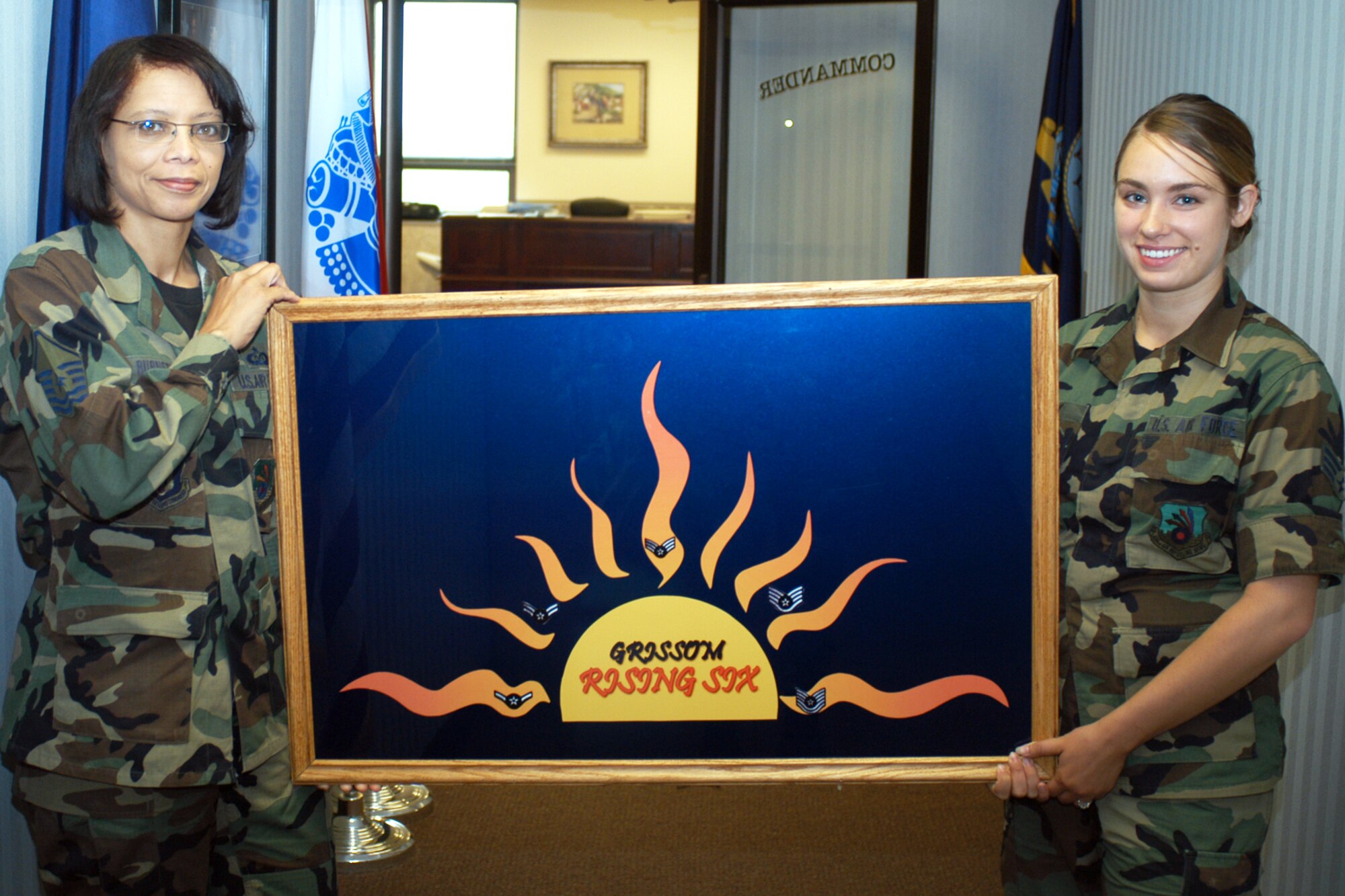 GRISSOM AIR RESERVE BASE, Ind., -- Master Sgt. Trudy Burnett, chief chaplain assistant, and Senior Airman Krista Kulak, the 434th Air Refueling Wing executive officer's assistant, display the Rising Six Council logo. The Rising Six Council's purpose is to establish and maintain a spirit of camaraderie and esprit de corps that will enhance the prestige of all Airmen and junior non-commissioned officers. (U.S. Air Force photo/Senior Airman Carl Berry)                               