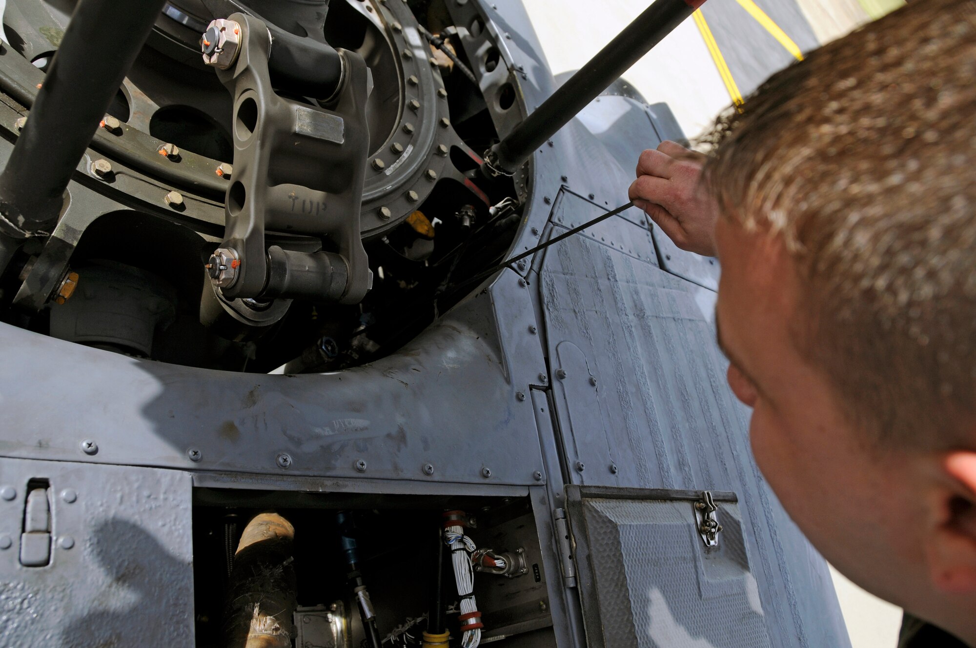Staff Sgt. Matthew Reihle, 48th Aircraft Maintenance Squadron HH-60G helicopter crew chief checks the oil level on an HH-60G Pave Hawk, July 10 at RAF Lakenheath, England. Crew chiefs inspect the helecopters fluid levels and any obvious signs of wear and tear after each flight. (U.S. Air Force photo by Airman Perry Aston) 