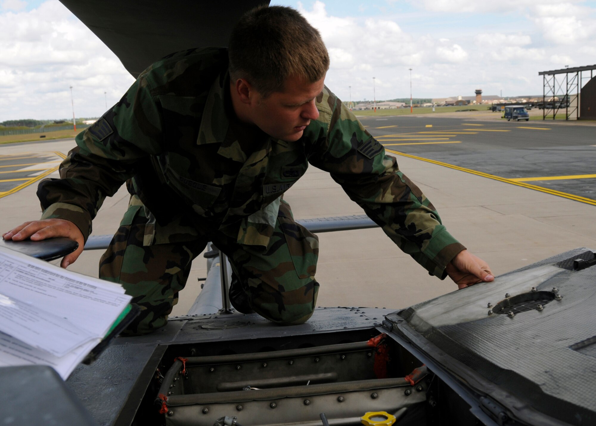 Staff Sgt. Joseph Busque, 48th Aircraft Maintenance Squadron HH-60G helicopter crew chief inspects the engine door latches for cracks and proper operation, July 10 at RAF Lakenheath, England. The crew chiefs will later do a more thorough inspection on the helicopter in a hanger. (U.S. Air Force photo by Airman Perry Aston) 