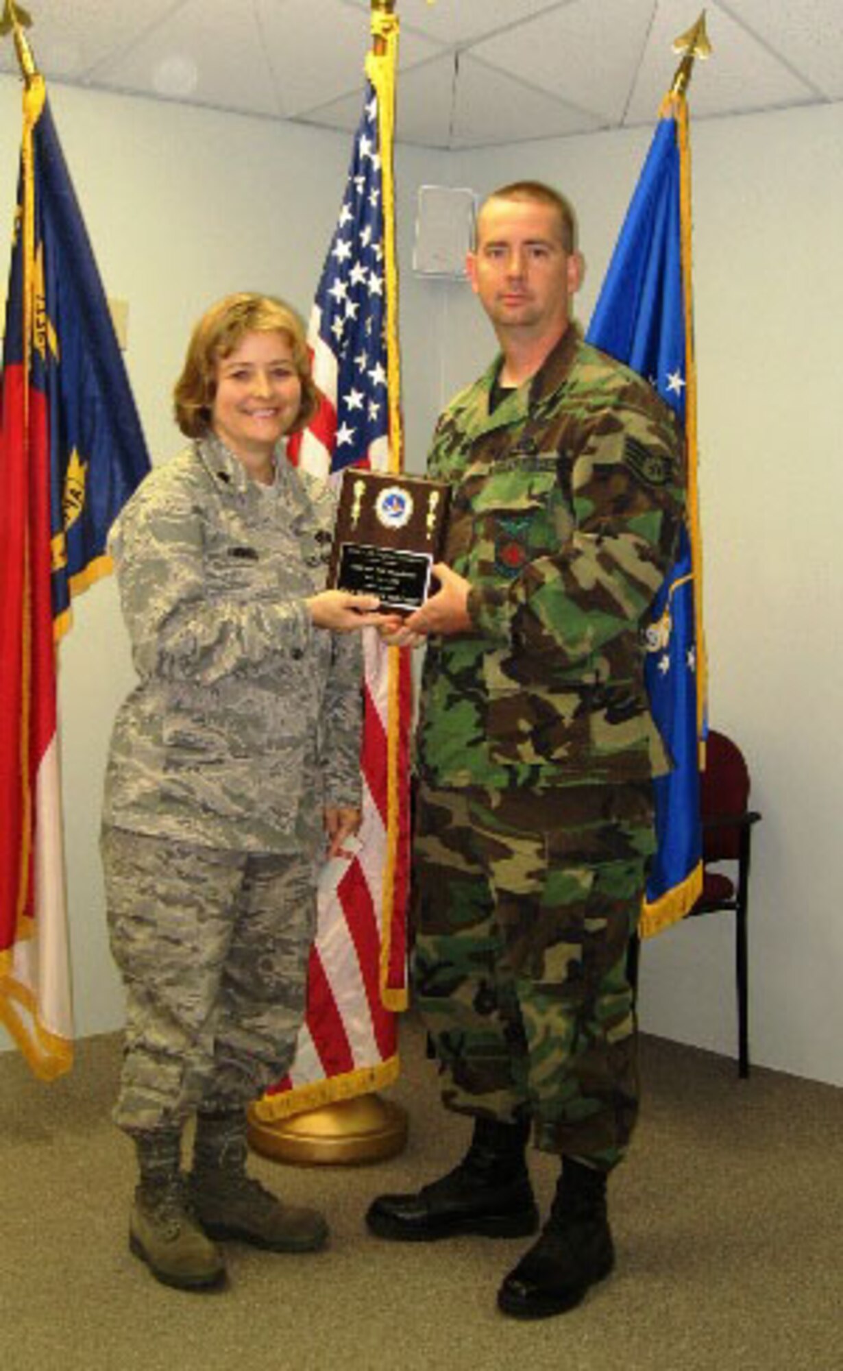 SEYMOUR JOHNSON AIR FORCE BASE, N.C. -- Staff Sgt. Bradley Robinson (right) receives the 916th Civil Engineer Squadron Non-Commissioned Officer of the Quarter award from Lt. Col. Kerri Grimes, squadron commander.  Sgt. Robinson just returned from a six-month deployment to Balad, Iraq.  
