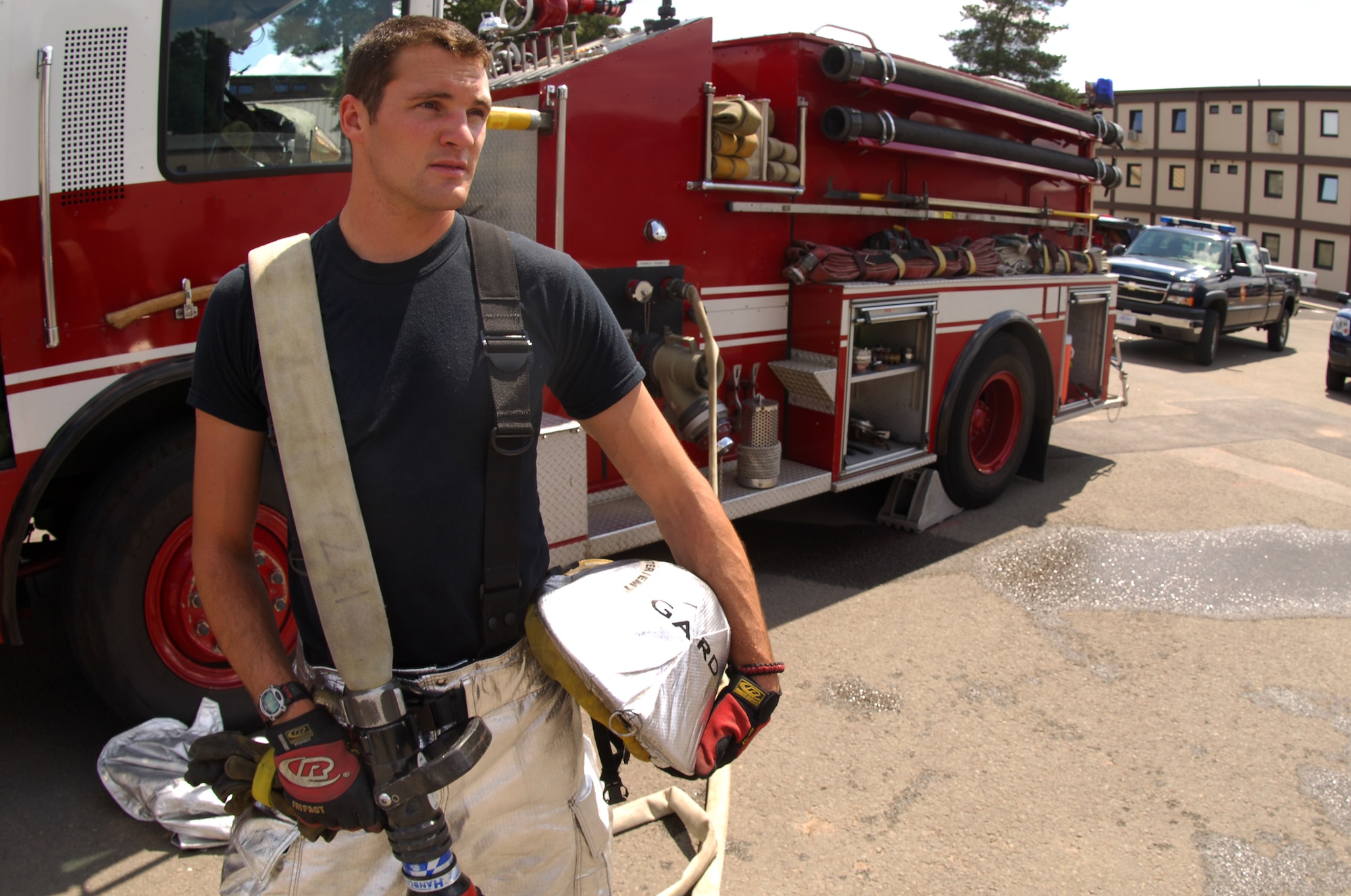 Senior Airman Andrew Gard, 835th Civil Engineering Squadron, rests after participating in a monthly Hazardous Materials Exercise, June 21, Ramstein Air Base, Germany.  Senior Airman Gard has received the Air Force firefighter of the year award and is now up for the award at the Department of Defense level.  (U.S. Air Force photo by Airman 1st Class Amber Bressler)(Released)