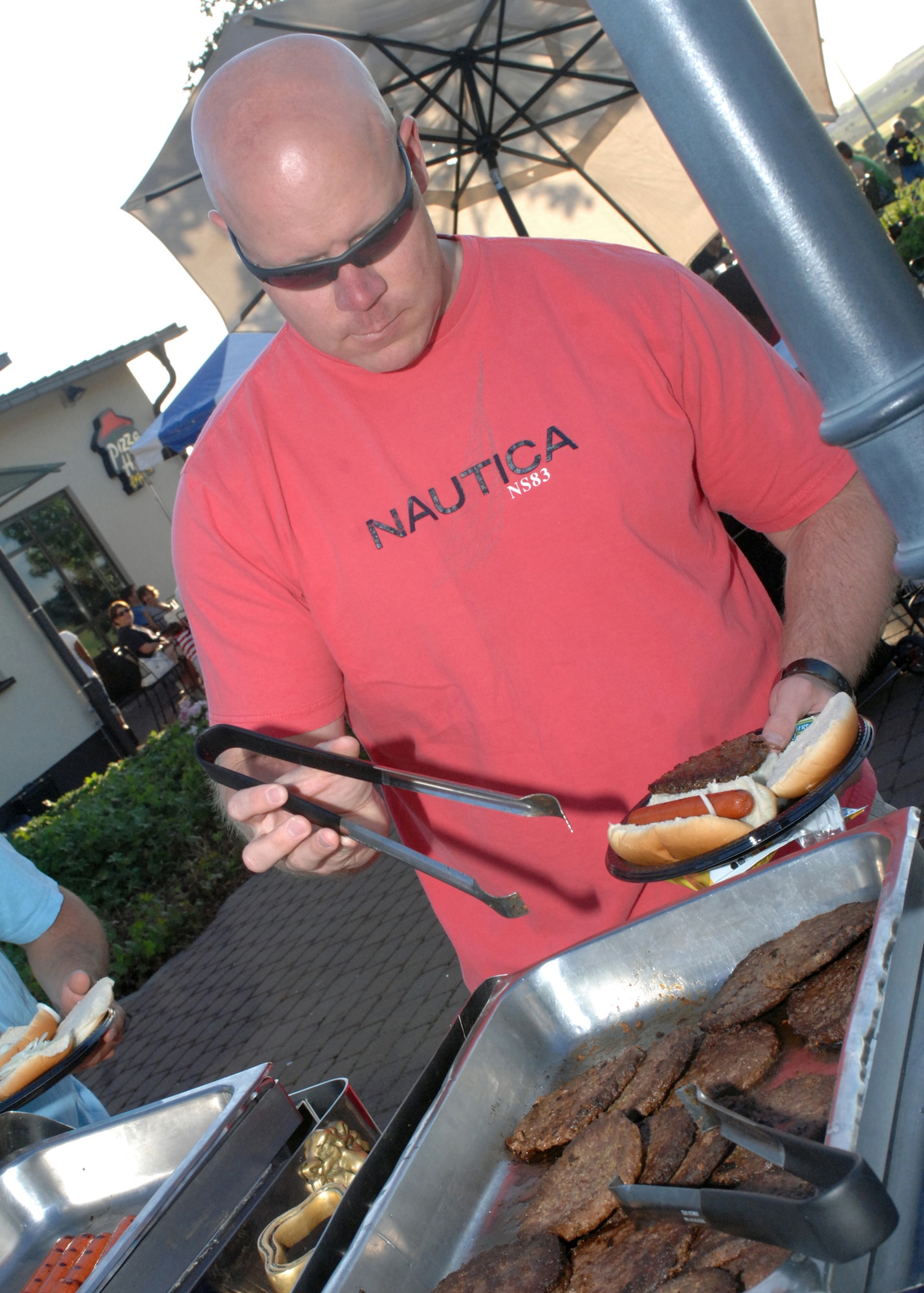 SPANGDAHLEM AIR BASE, Germany-- Maj. Dan OKeefe, 313 Airlift Squadron, McChord Air Force Base, enjoys a burger during the Independence Day Extravaganza held at Club Eifel July 4, 2008. U.S. Air Force Photo by Airman 1st Class Jenifer Calhoun