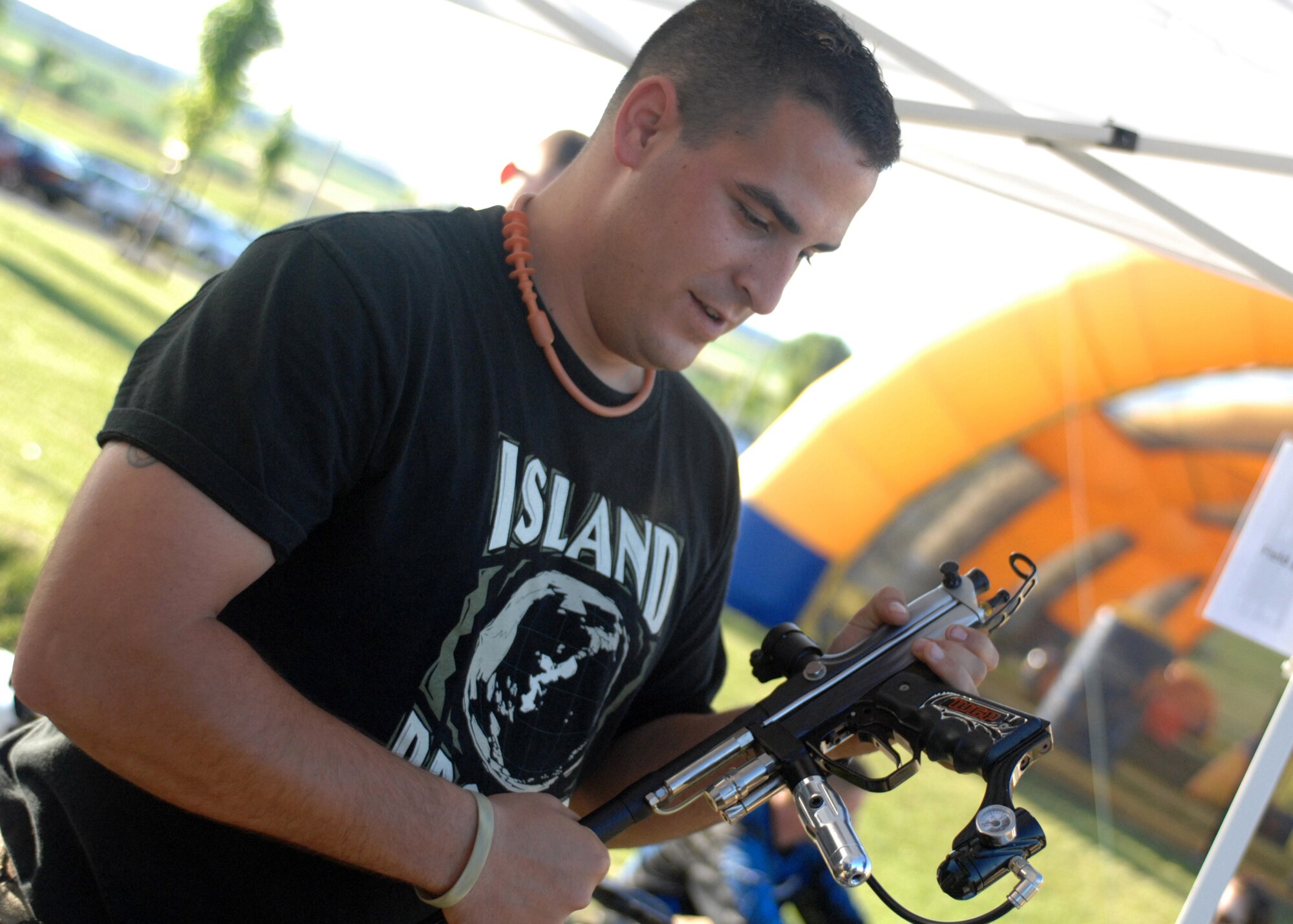 SPANGDAHLEM AIR BASE, Germany- Airman 1st Class Christopher Mazzoli, 52nd Logistics Readiness Squadron, prepares a paintball gun that was used in a game at the Independence Day Extravaganza July 4, 2008.  Paintball, along with a Burger Burn and Jeep Jouster, were just a few of the activities offered. U.S. Air Force Photo by Airman 1st Class Jenifer Calhoun