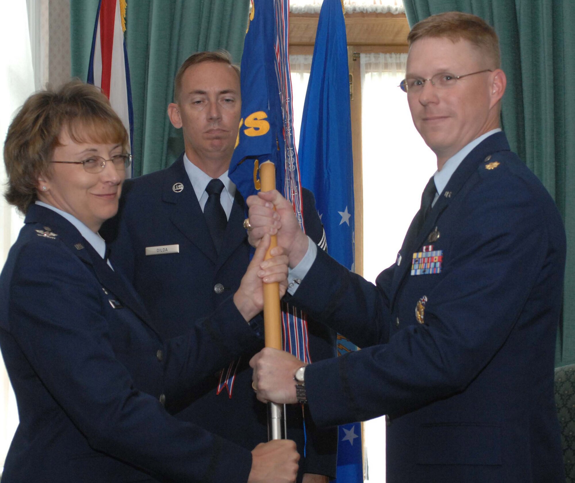 RAF MILDENHALL, England -- Col. Eden Murrie, 100th Air Refueling Wing commander, presents the squadron guide-on July 15 to Major Davis H. Maulding, incoming 100th Comptroller Squadron commander. Maj. Maulding is assuming command from Lt. Col. Stephen G. Hoffman. (U.S Air Force photo by Airman 1st Class Brad Smith) 