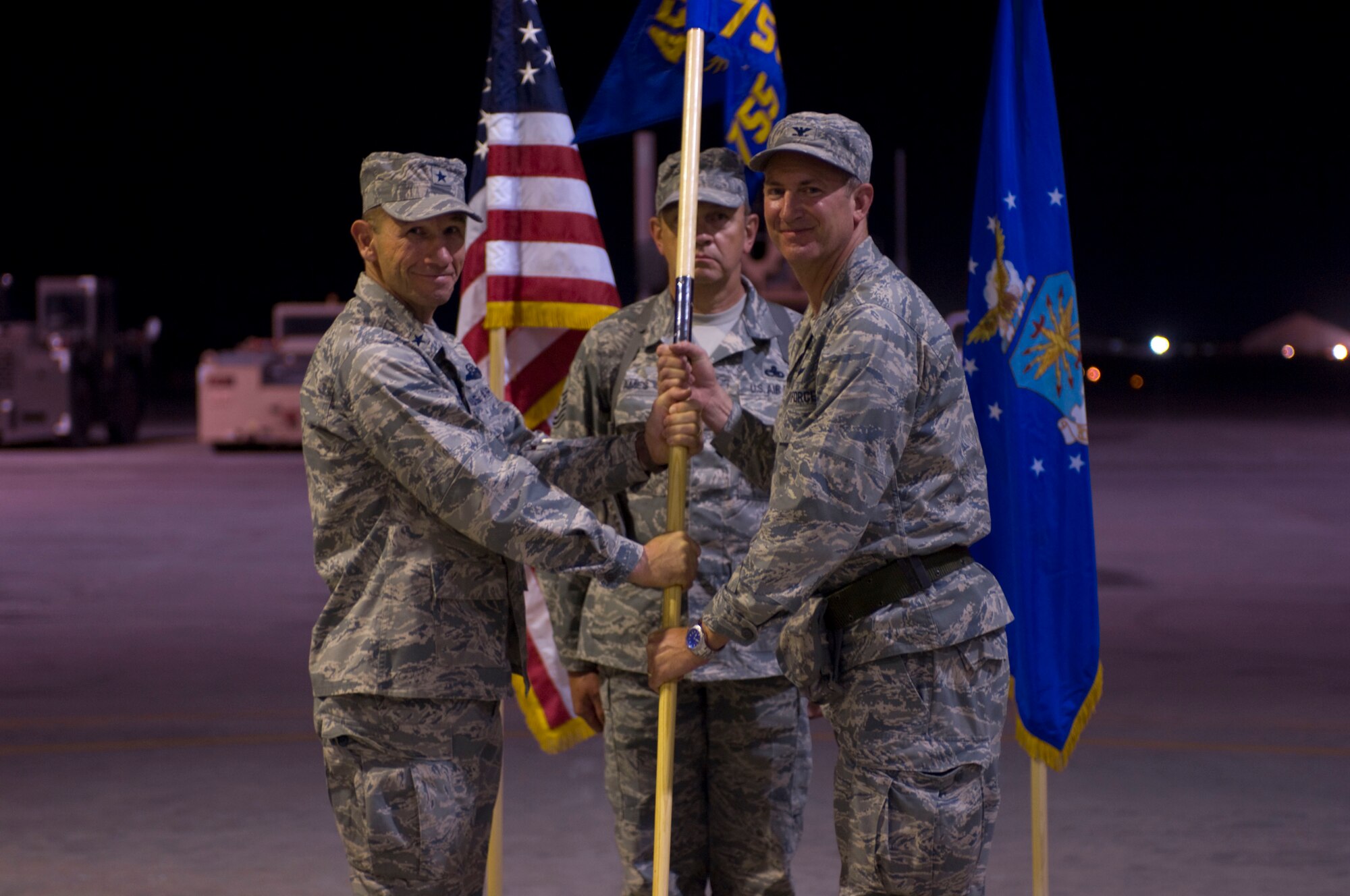 BAGRAM AIR FIELD, Afghanistan -- Brig. Gen. Mike Holmes, commander of the 455th Air Expeditionary Wing, passes the 755th Air Expeditionary Group's guideon to Col. James Reed, commander of the 755th AEG, here on July 11, 2008. This symbolic gesture initiated Colonel Reed's command of the 755th AEG. (U.S. Air Force photo by Staff Sgt. Samuel Morse)