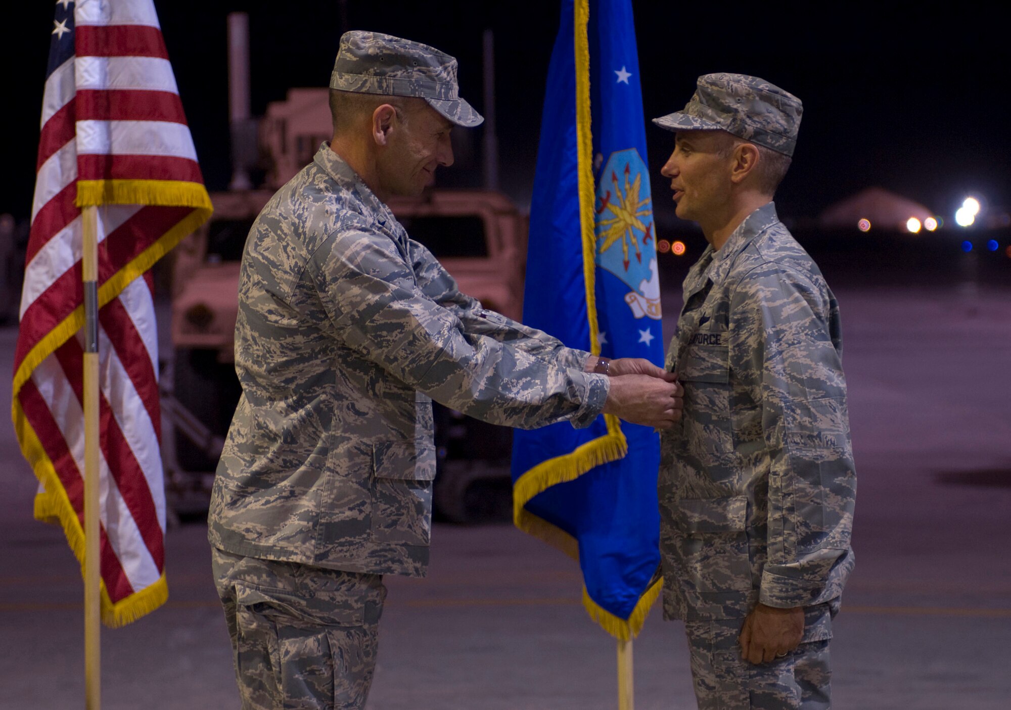 BAGRAM AIR FIELD, Afghanistan -- Brig. Gen. Mike Holmes, commander of the 455th Air Expeditionary Wing, pins the Bronze Star Medal on Col. Thomas Huizenga, commander of the 755th Air Expeditionary Group, here on July 11, 2008. Colonel Huizenga distinguished himself through meritorious achievement as commander of the 755th AEG from August 16, 2007, to July 11, 2008. (U.S. Air Force photo by Staff Sgt. Samuel Morse)